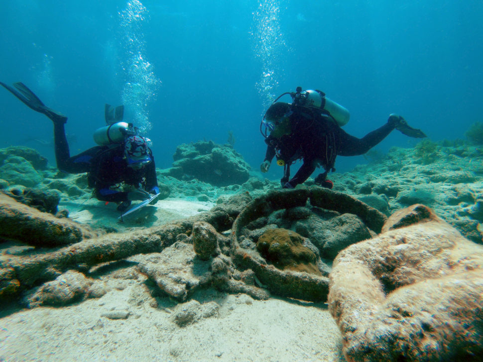 Divers investigating an artifact.