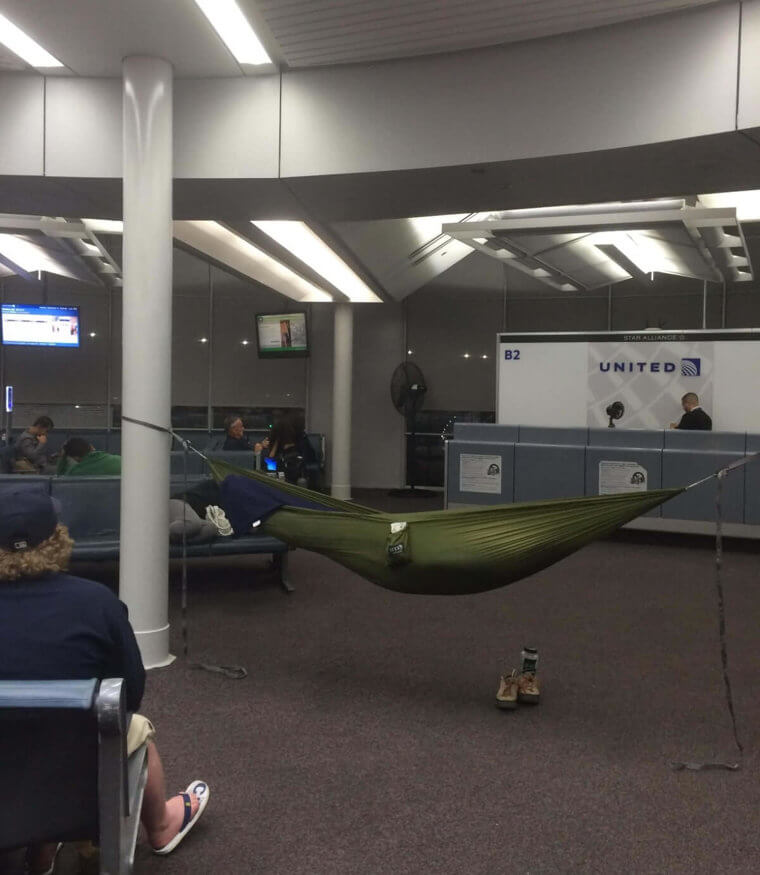 person sleeping in Hammock in airport