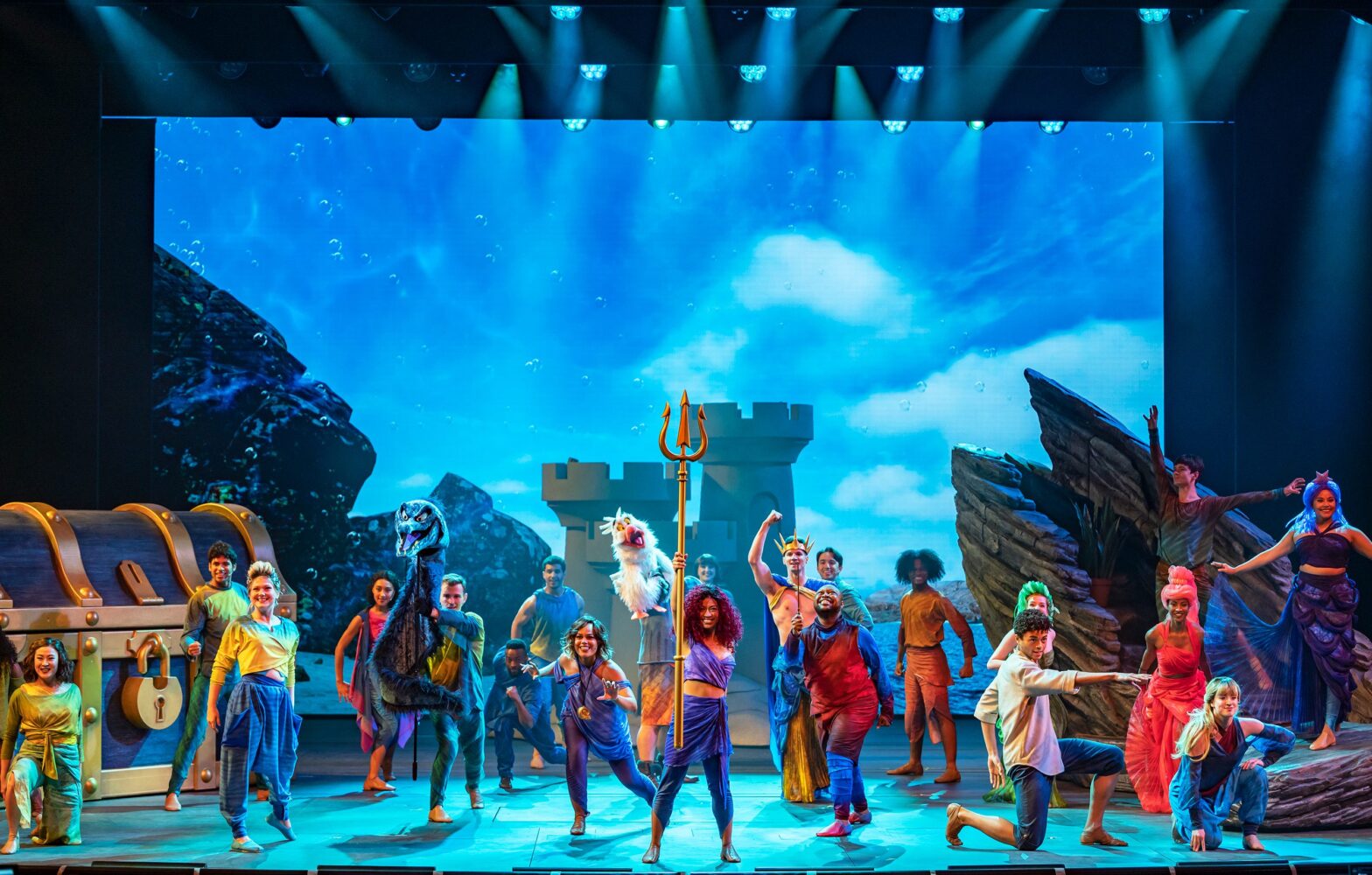 image of people standing on stage performing in the Little Mermaid musical