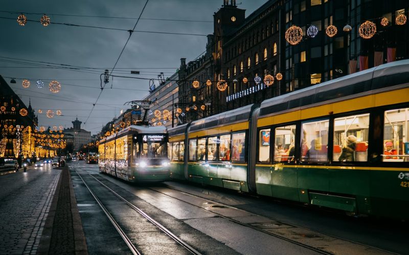 finland named world's happiest countries in 2023 - view of street in helsinki with tram cars in the at dusk in the afternoon