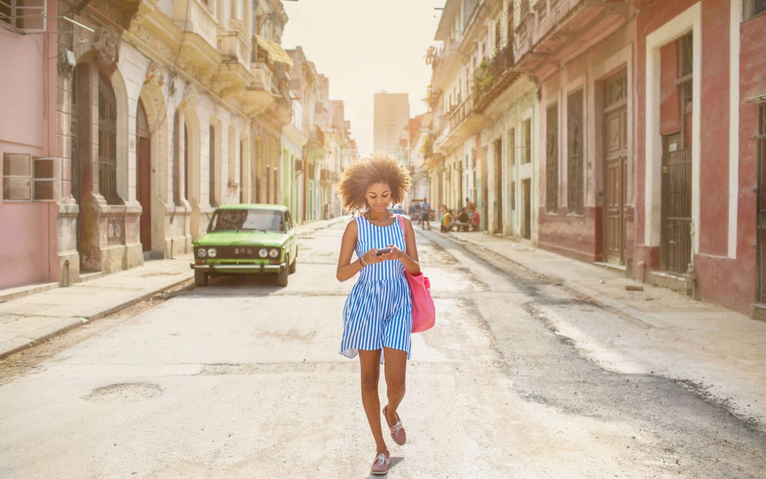 woman walking in street in Cuba - best urban adventures in Latin America