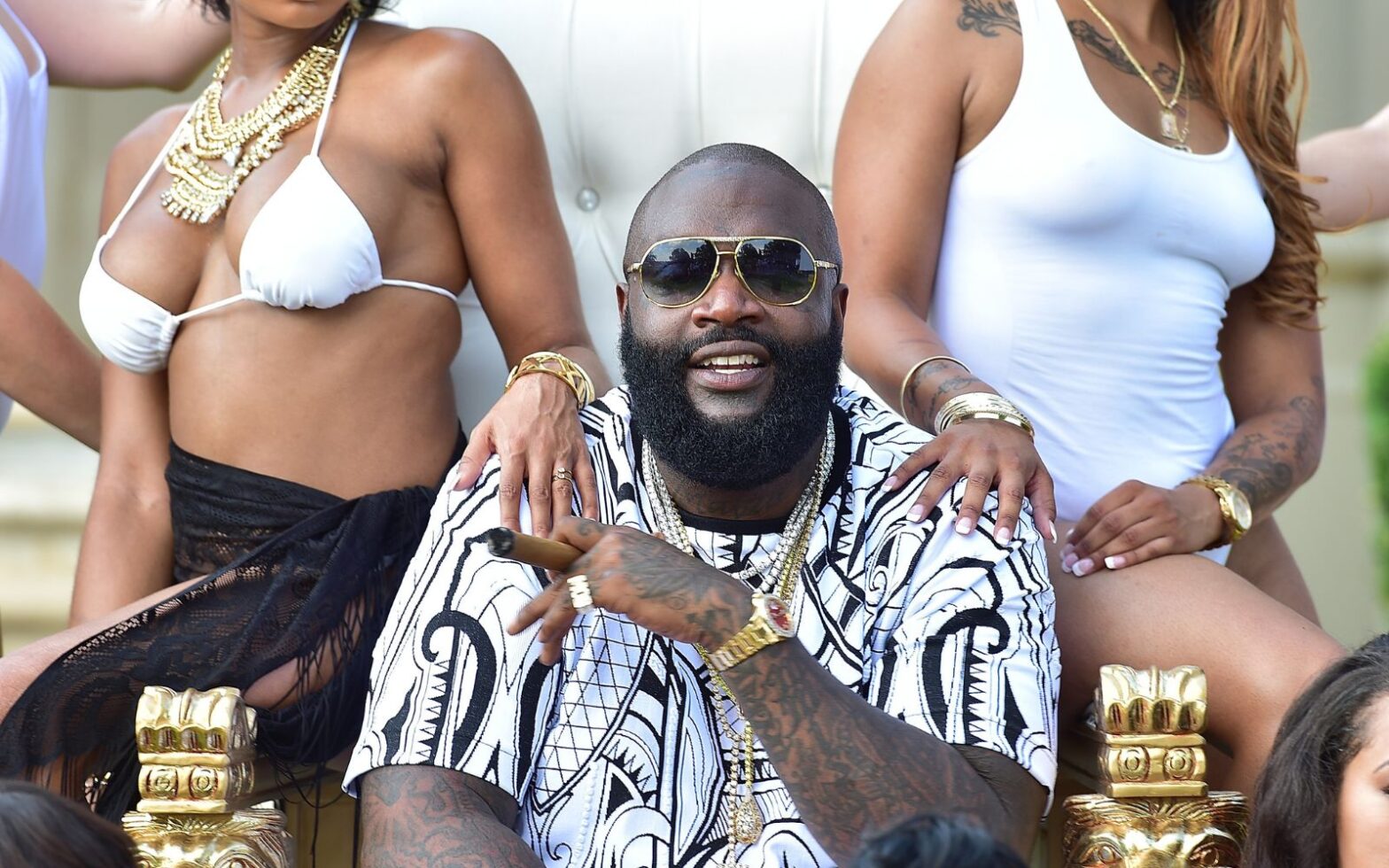 Rick Ross surrounded by beautiful women - Rick Ross Takes Vacation to Jamaica