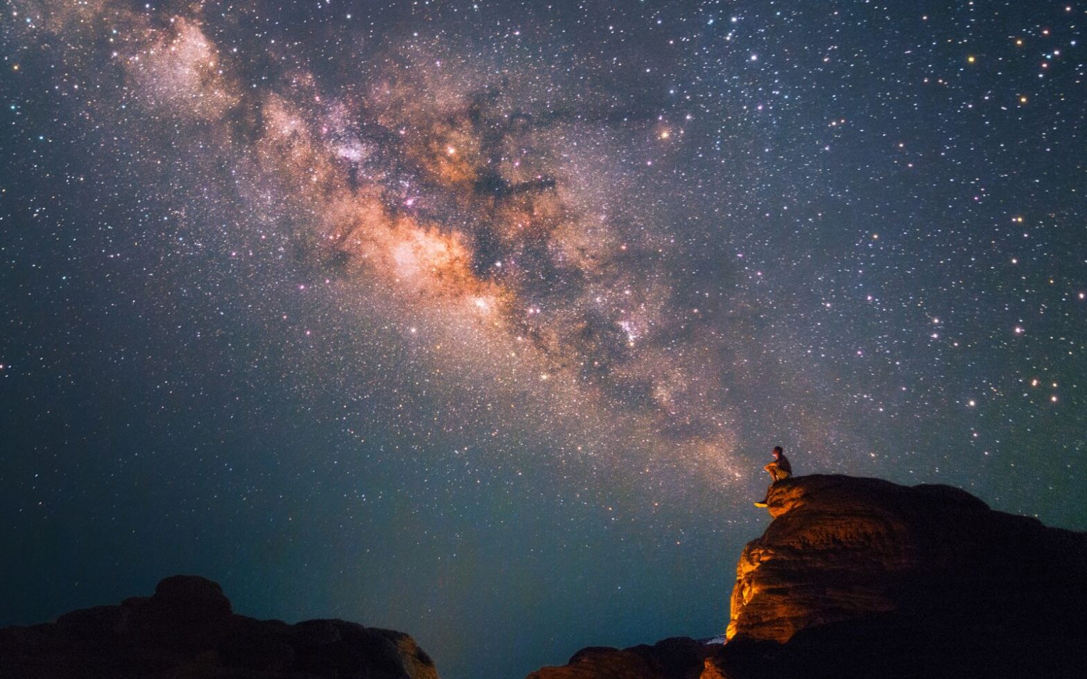 man looking at the Milky Way Stars shining above the Grand Canyon - stargazing parks in the Americas