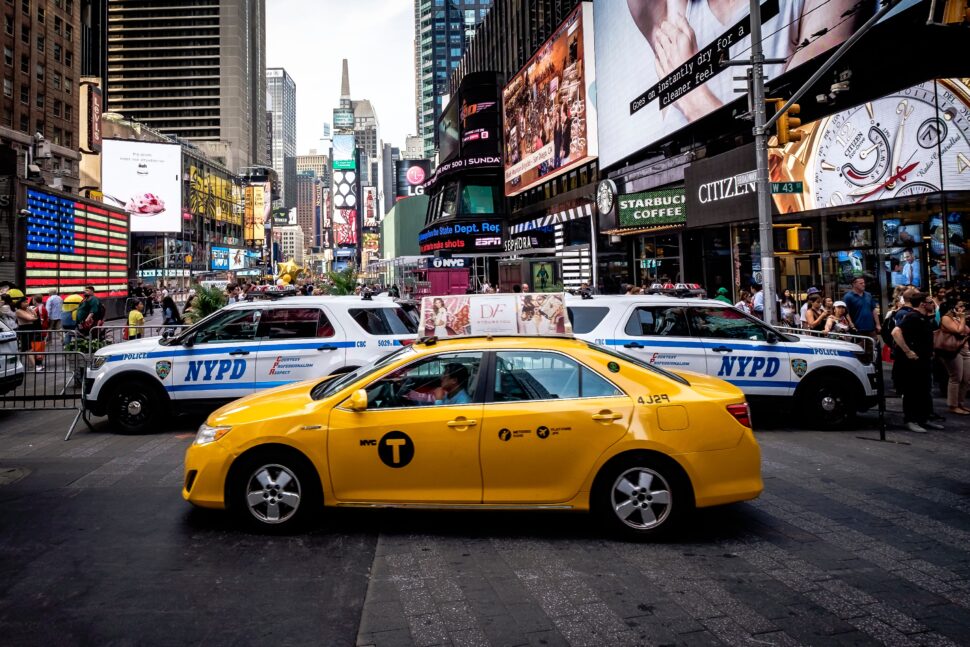 Yellow taxi driving in Times square - fastest way to get to JFK from Manhattan