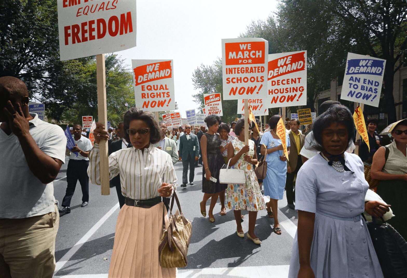 Black women holding signs during a march