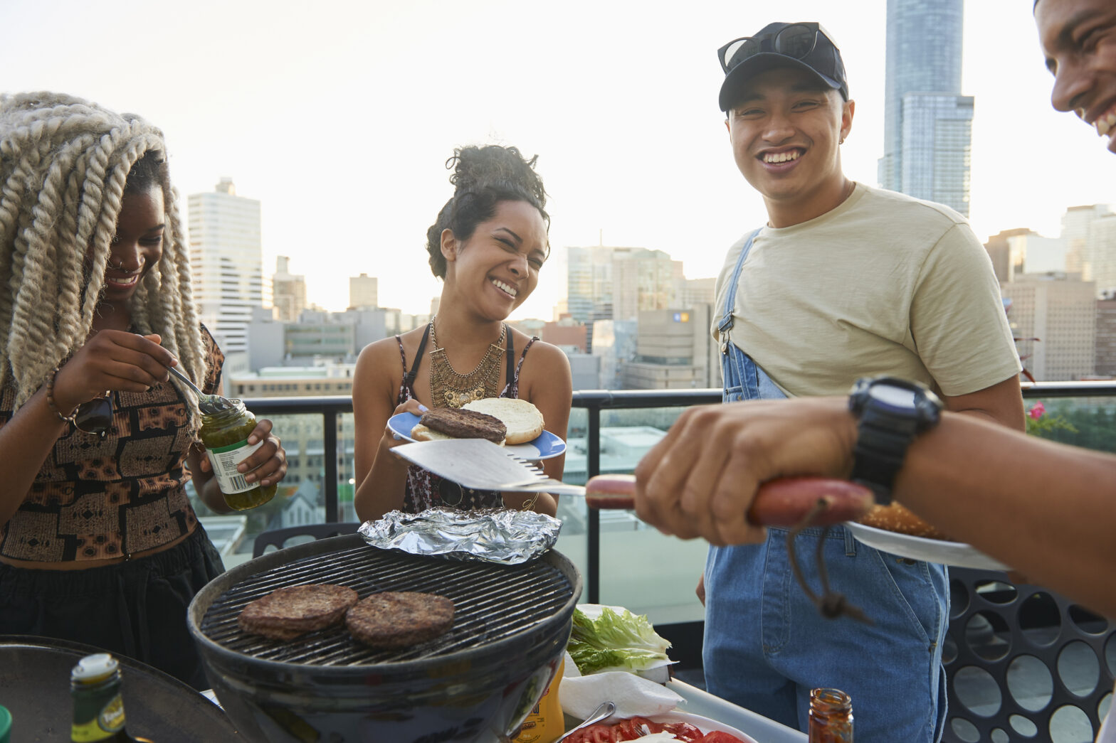 Group of young millennial enjoying a rooftop bbq