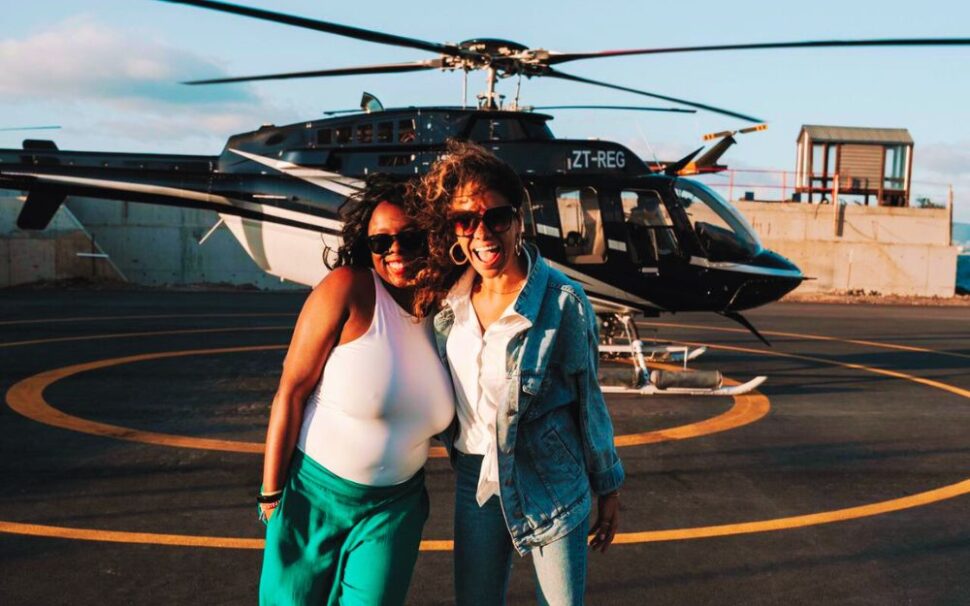 two black women in front of helicopter in Cape Town