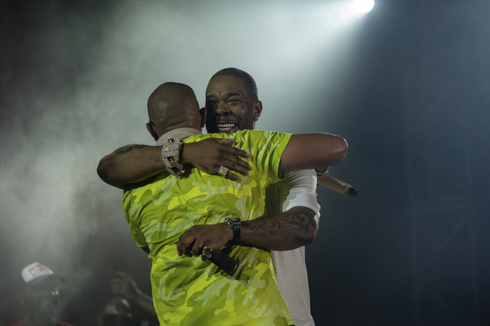 Busta Rhymes and Sean Paul hugging on stage after performing at the Out of This World Music Fest in the Cayman Islands