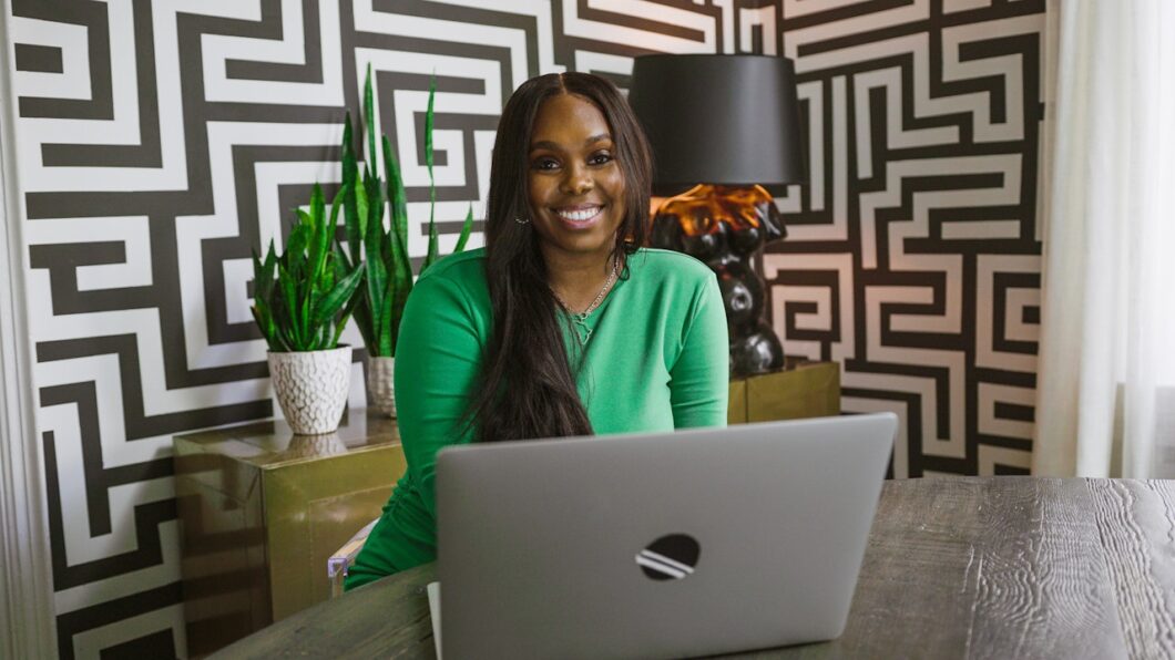 Black woman at laptop - Caribbean-owned business to support during Caribbean Heritage Month