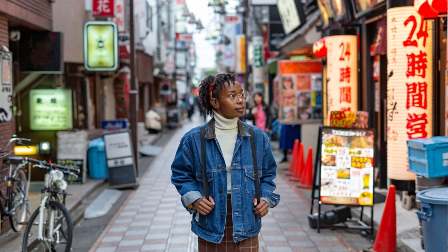 Black woman walking on the a street in Tokyo - safest country for solo travel