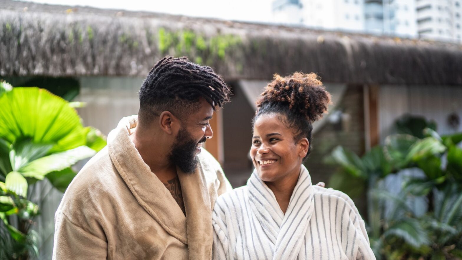 Black couple wearing robes at luxury spa