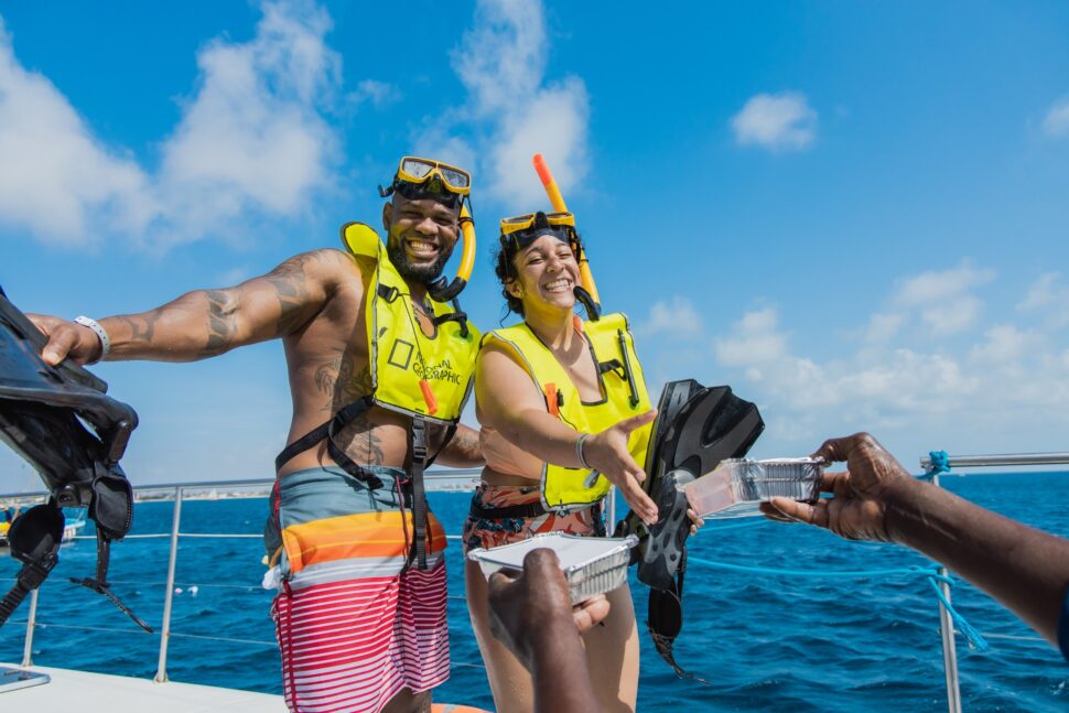 couple wearing snorkeling gear on a boat