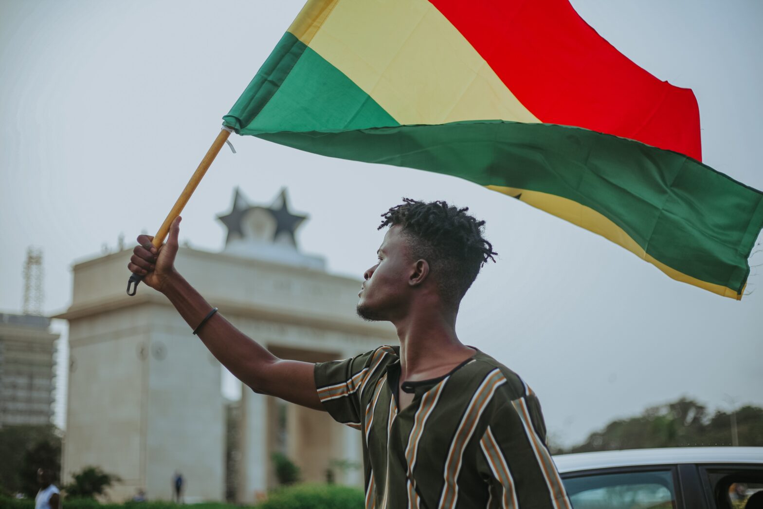 man holding Ghana flag