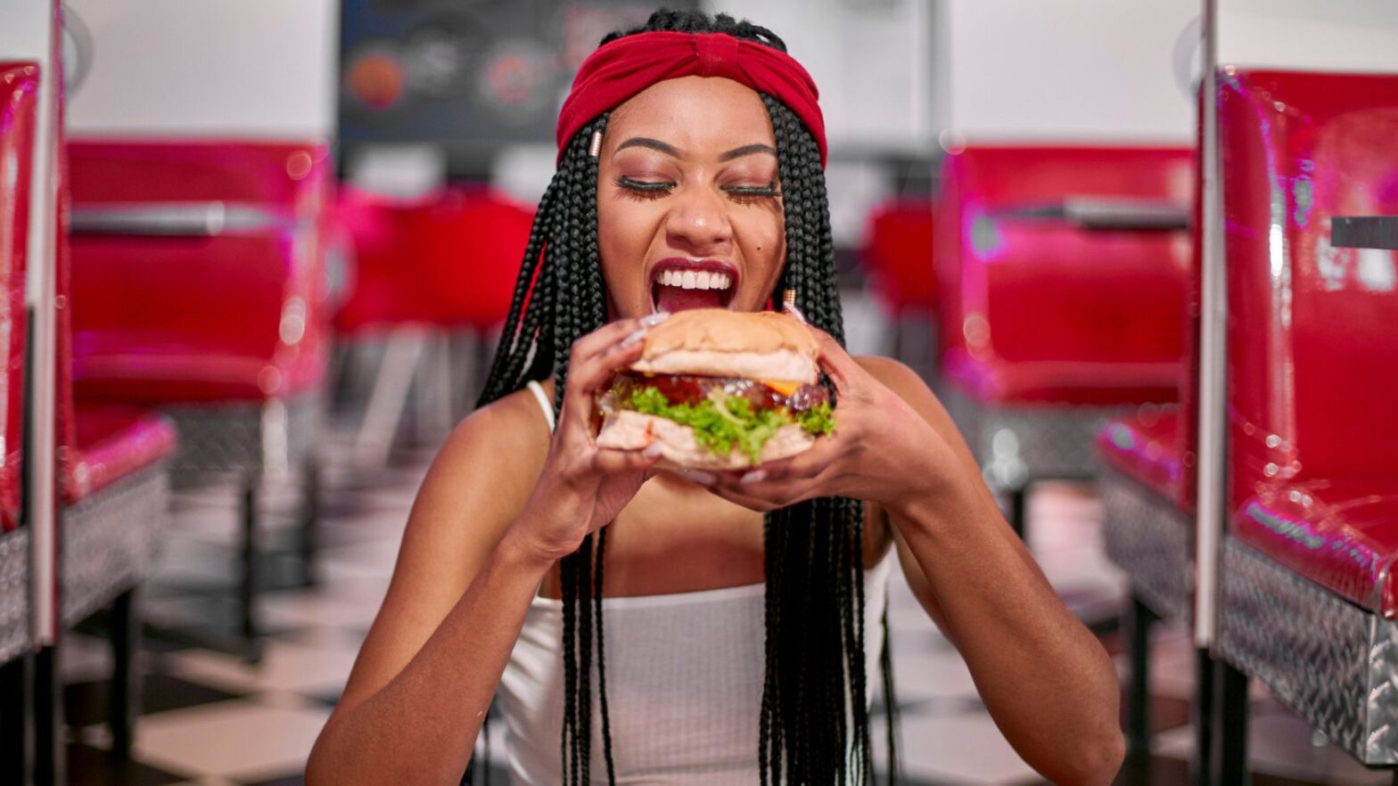 woman eating a big burger