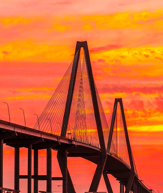 Wondering where to stay in Charleston, SC? We have the answers here in this travel guide to the area. Pictured for you is one of the iconic bridges leading into Charleston, SC.
