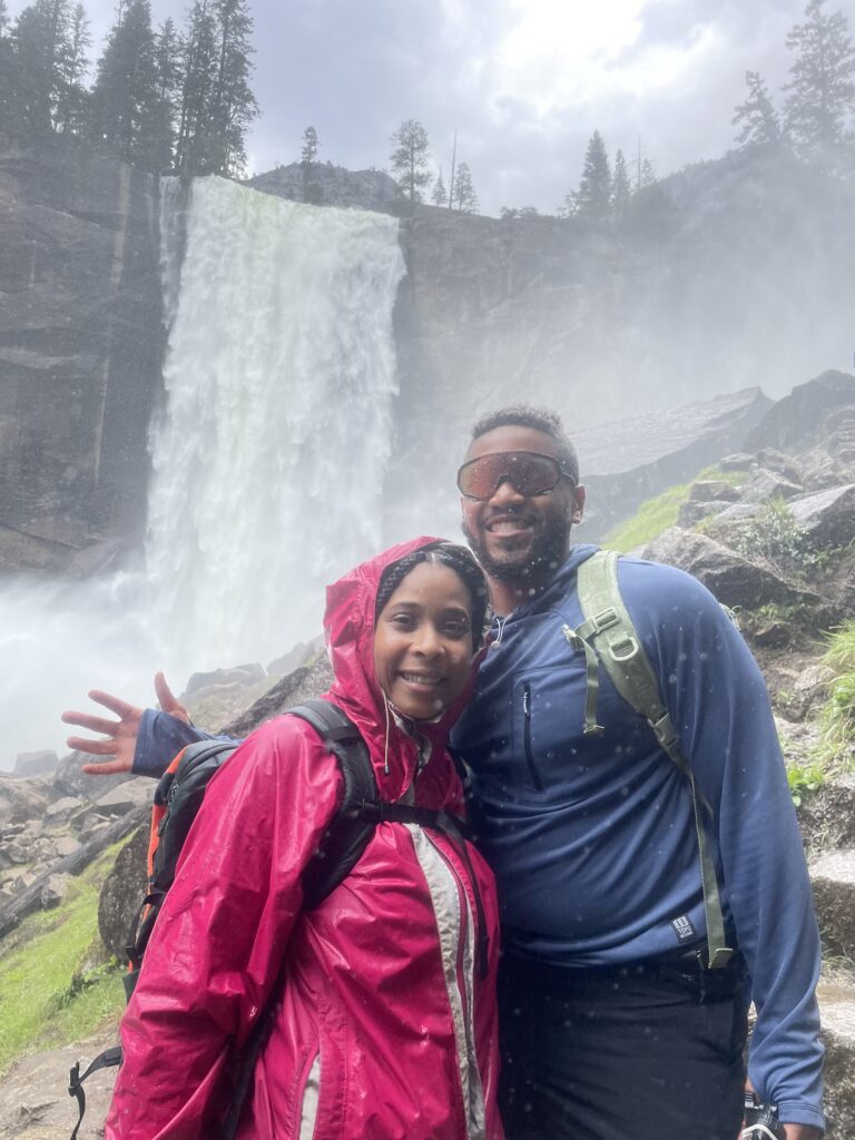 Black People Outside creators taking a picture in front of a waterfall.