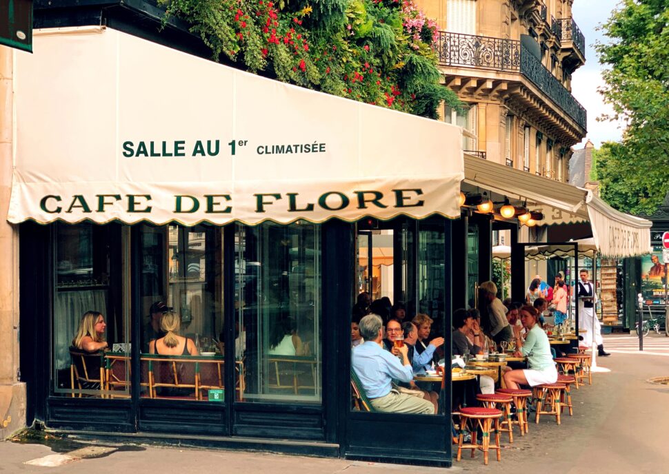 The Quartier Saint-Germain-des-Prés is a foodie paradise. Check out the local food culture that thrives in this Paris arrondissement.
pictured: A cafe in Paris' Quartier Saint-Germain-des-Prés with a full patio 