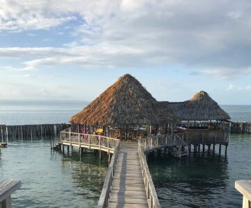 Book an overwater villa in this resort on a luxury private island during a visit to Belize. 