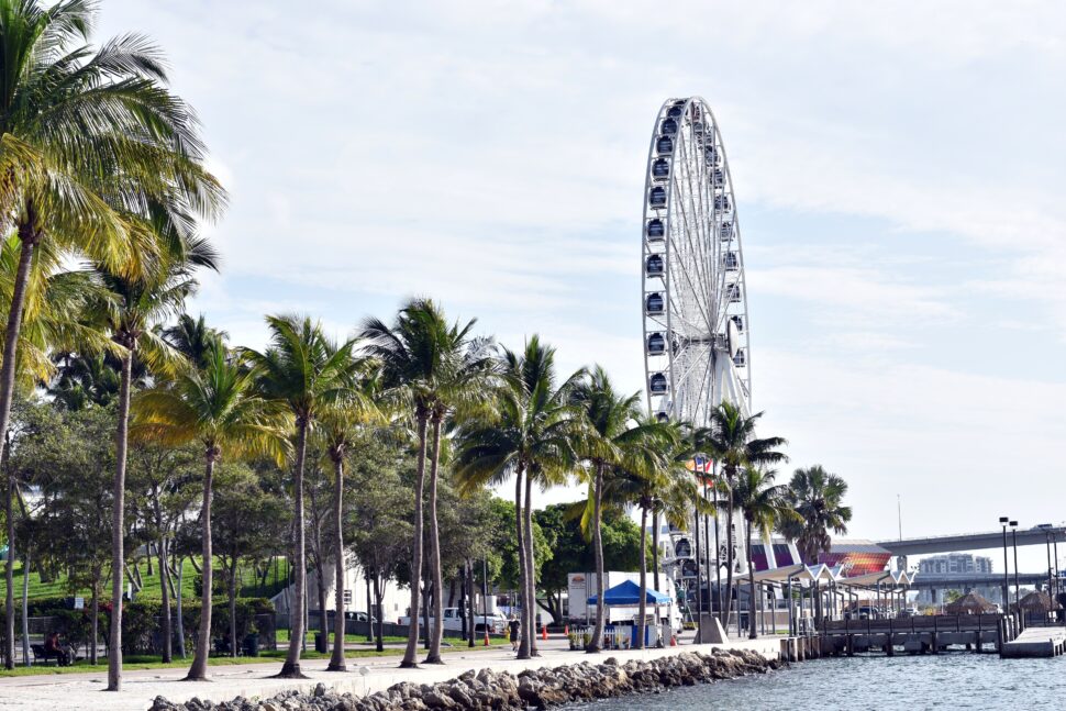 Miami is known for its fun beach culture but not many people know where to stay in Miami. Pictured: a ferris wheel near the Miami beach.