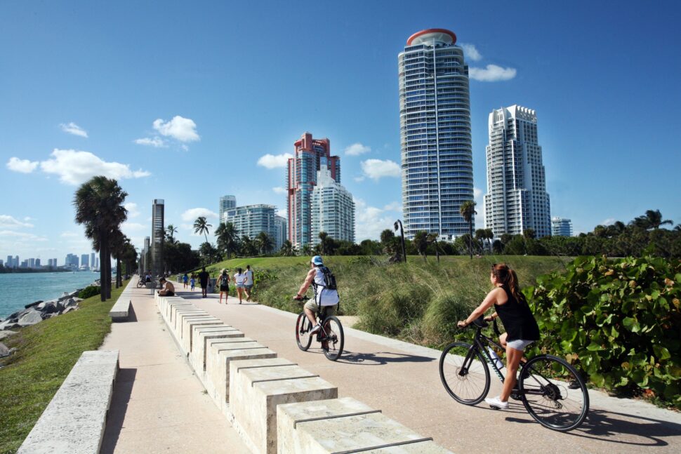 Miami's burroughs offer families plenty of activities to keep busy. Visitors can expect sunny and safe places to stay. Pictured: bikers near the Miami beach.