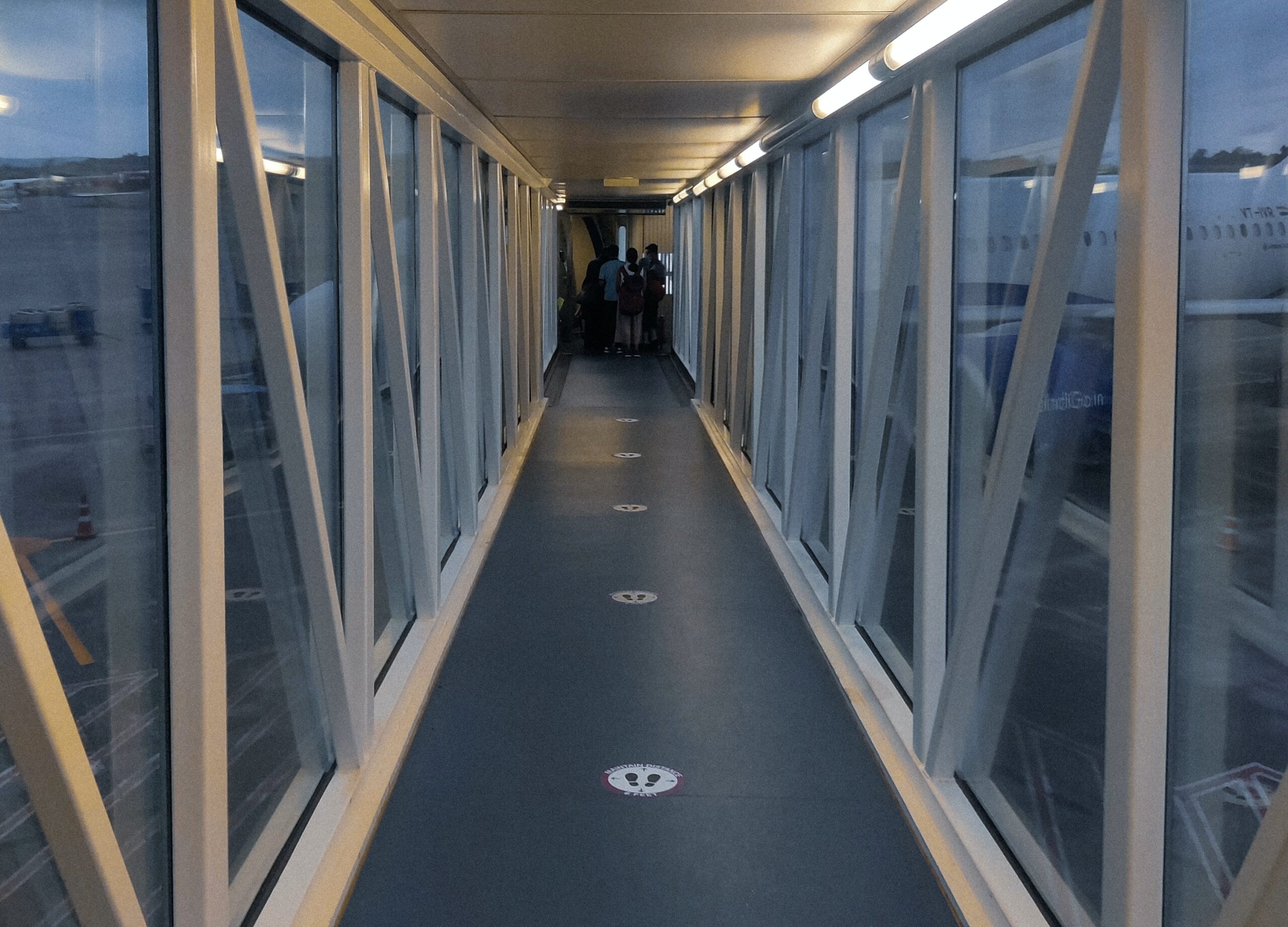 There are many safety regulations that airlines have to abide by to continue to fly passengers. Frontier is one of the many airlines that comply. 
Pictured: Airplane tunnel with passengers boarding 