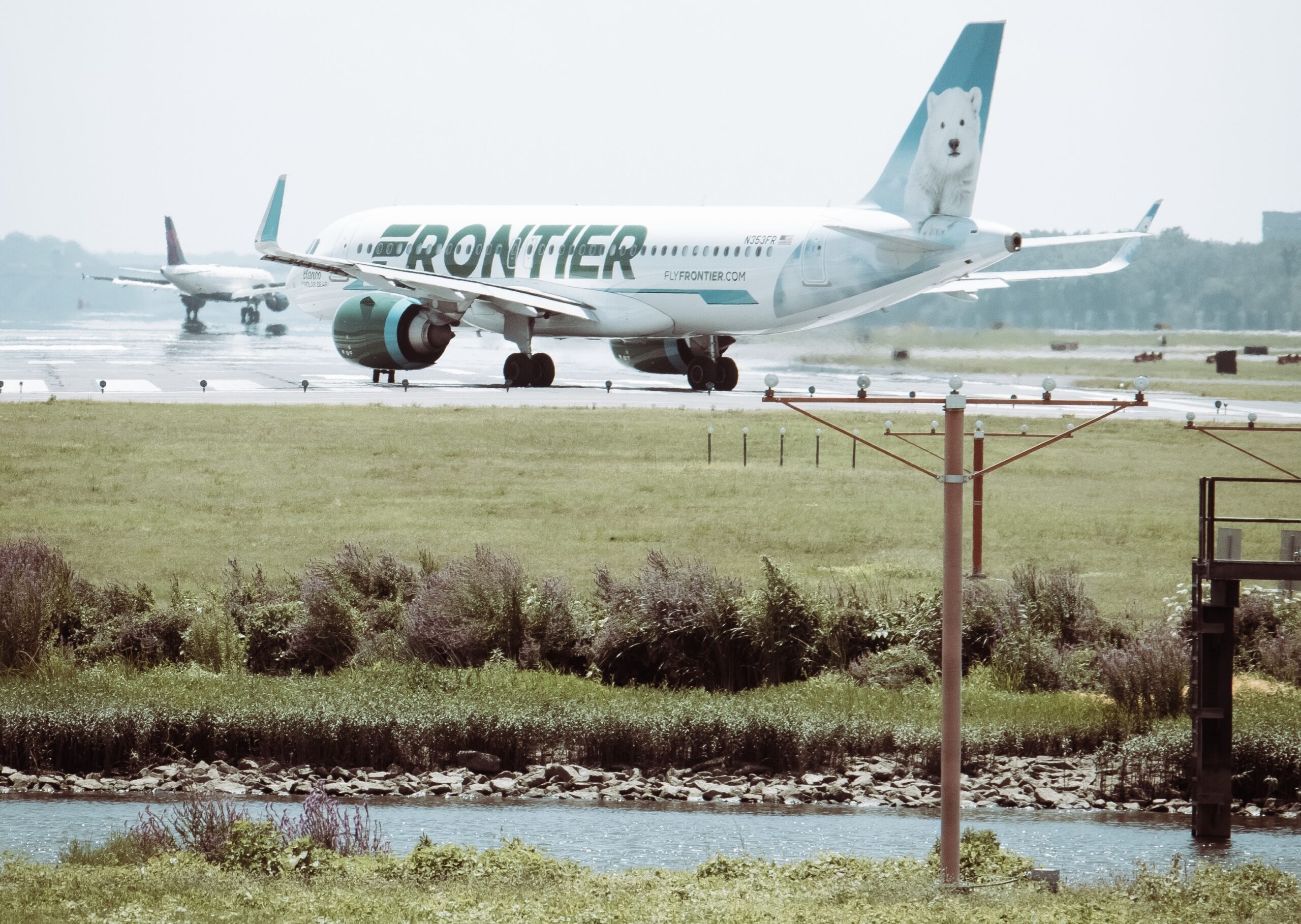 The cons of flying Frontier Airlines are some of the reasons the airline has mixed reviews. 
Pictured: A frontier aircraft with an image of a polar bear in the back wing