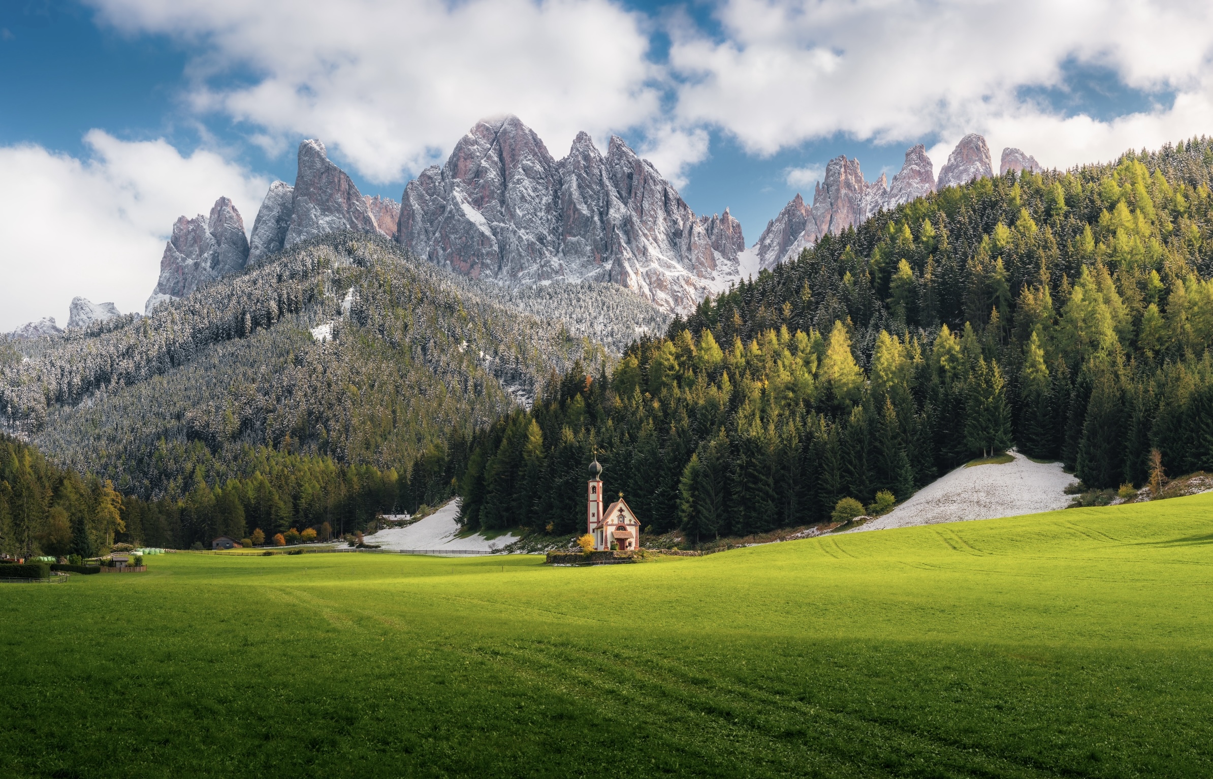 Dolomite, Italy is a beautiful mountain range that attracts many travelers every year.
Pictured: the Dolomite mountain range with snowy peaks and green valleys