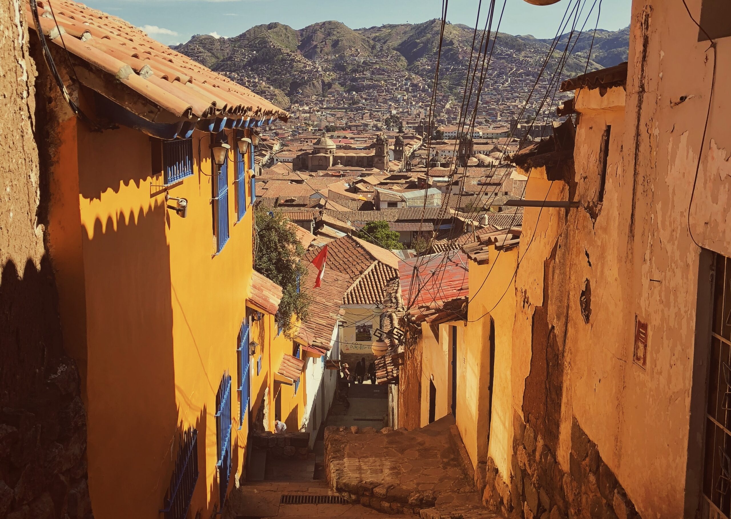 The safety of travelers in Peru is dependent on the area they stay in and information they research. Check out our top travel advisories for Peru. 
Pictured: Cusco, Peru with winding alleys and towering mountains 
