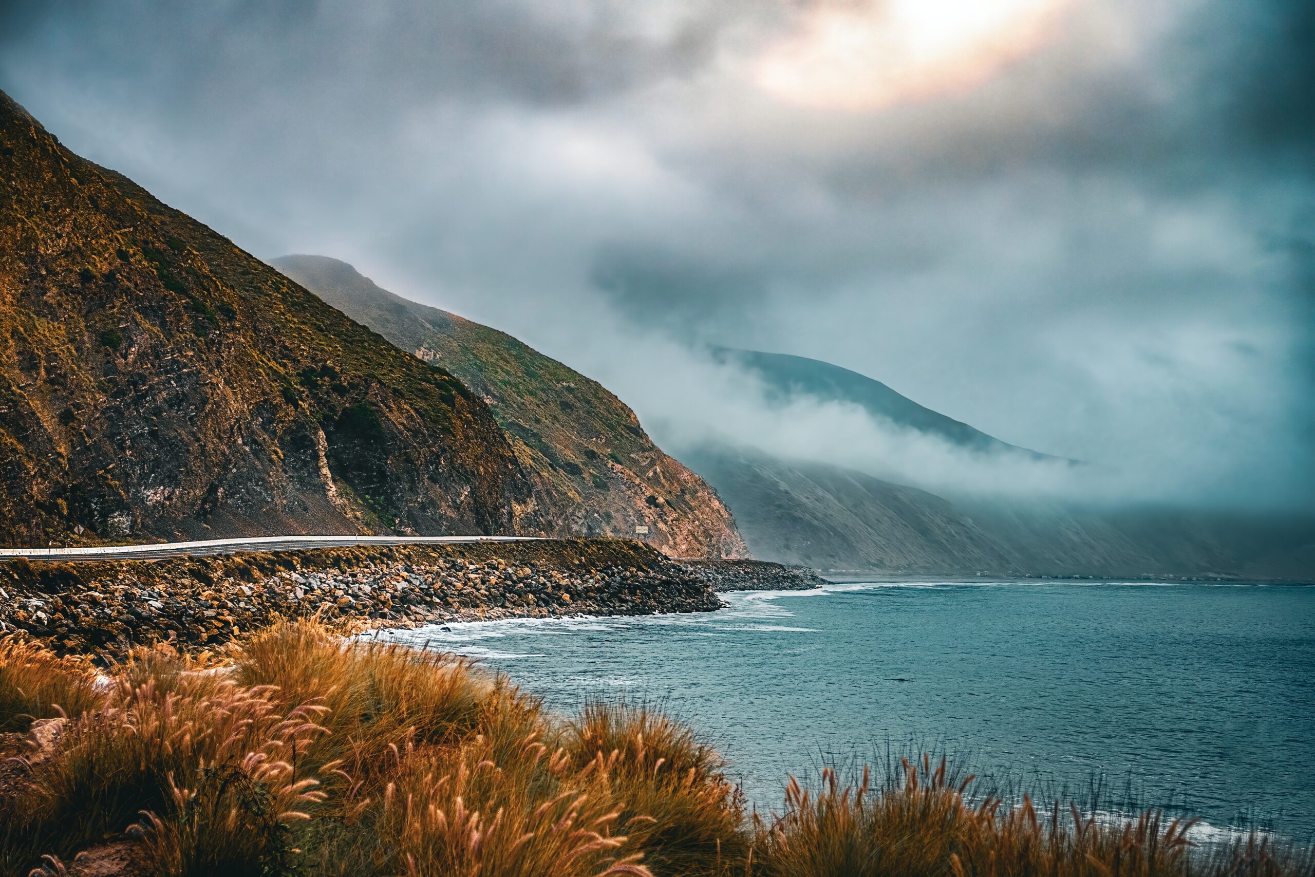 California's Point Mugu was an important filming location for the second Top Gun film.
pictured: The edge of a mountain in Point Mugu State Park and the tranquil coastal waters of the beach