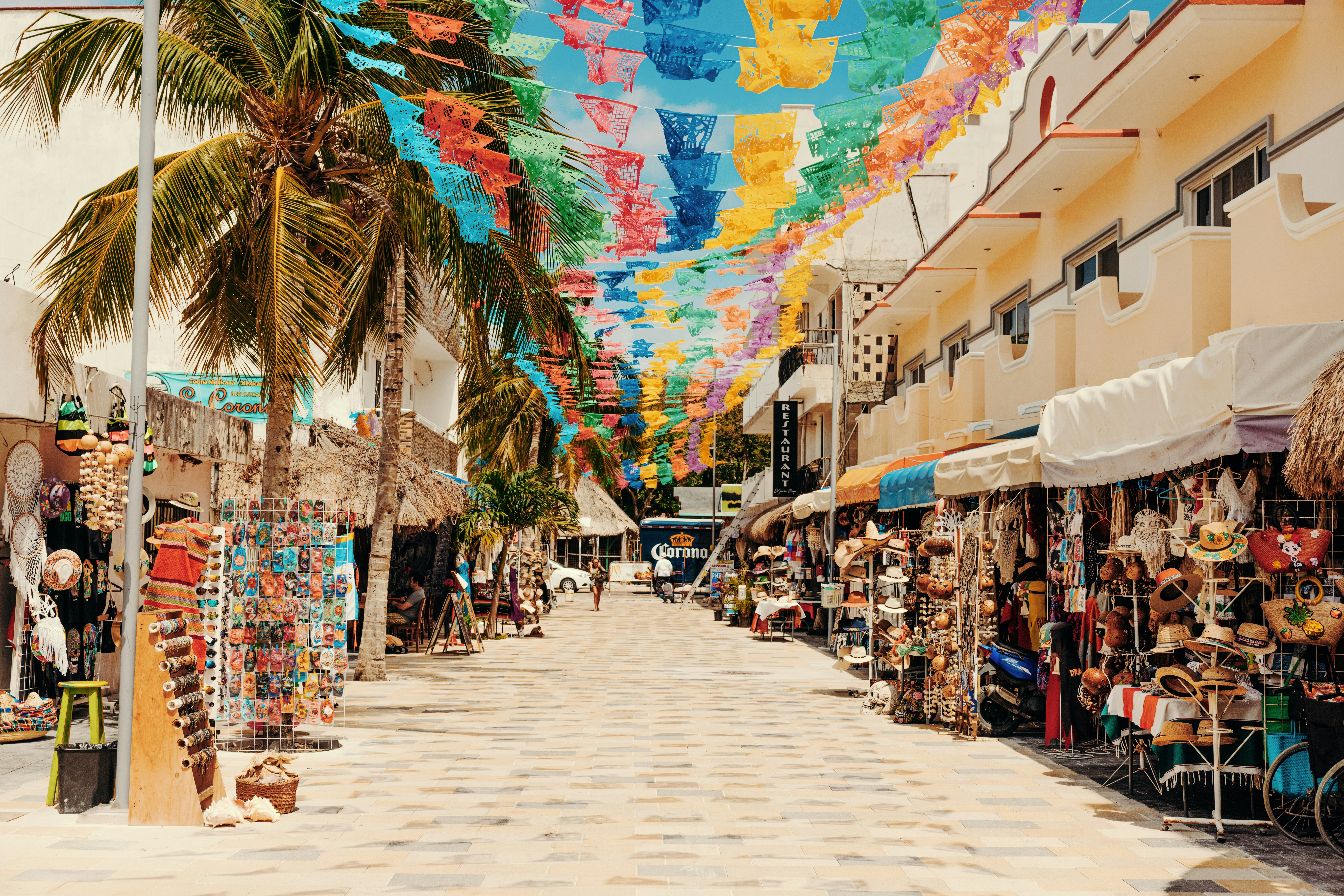 Cozumel is an island that offers a safe haven for travelers that do not want the buzz of other Mexican destinations.
pictured: A street in Cozumel filled with street vendors and shops 