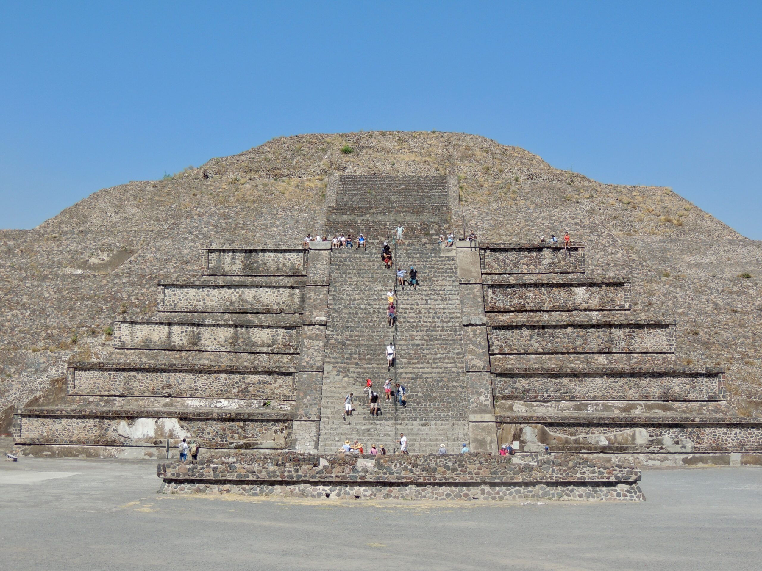 The Pyramid of the Sun is the most popular structure in the ancient city of Teotihuacán. 
pictured: The Pyramid of the Sun with visitors walking up the steep stairs of the pyramid 