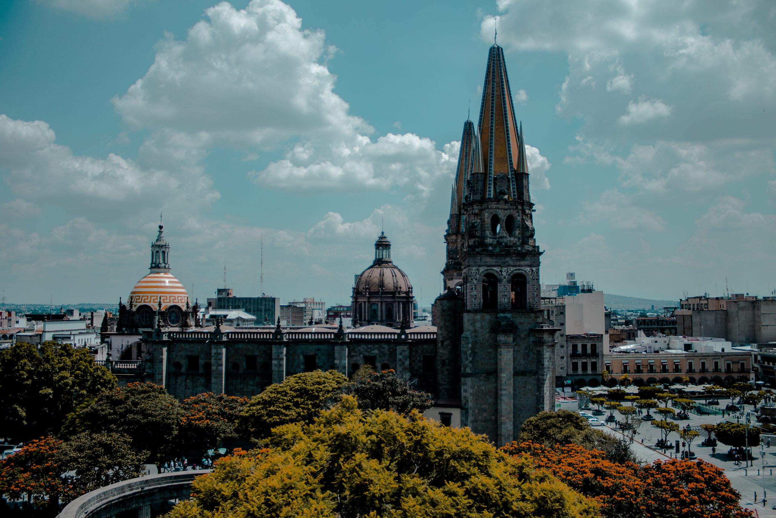 Check out the best times to visit Guadalajara, Mexico to have a safe visit.
pictured: the central city area of Guadalajara, Mexico during fall with historical buildings and cloudy skies 