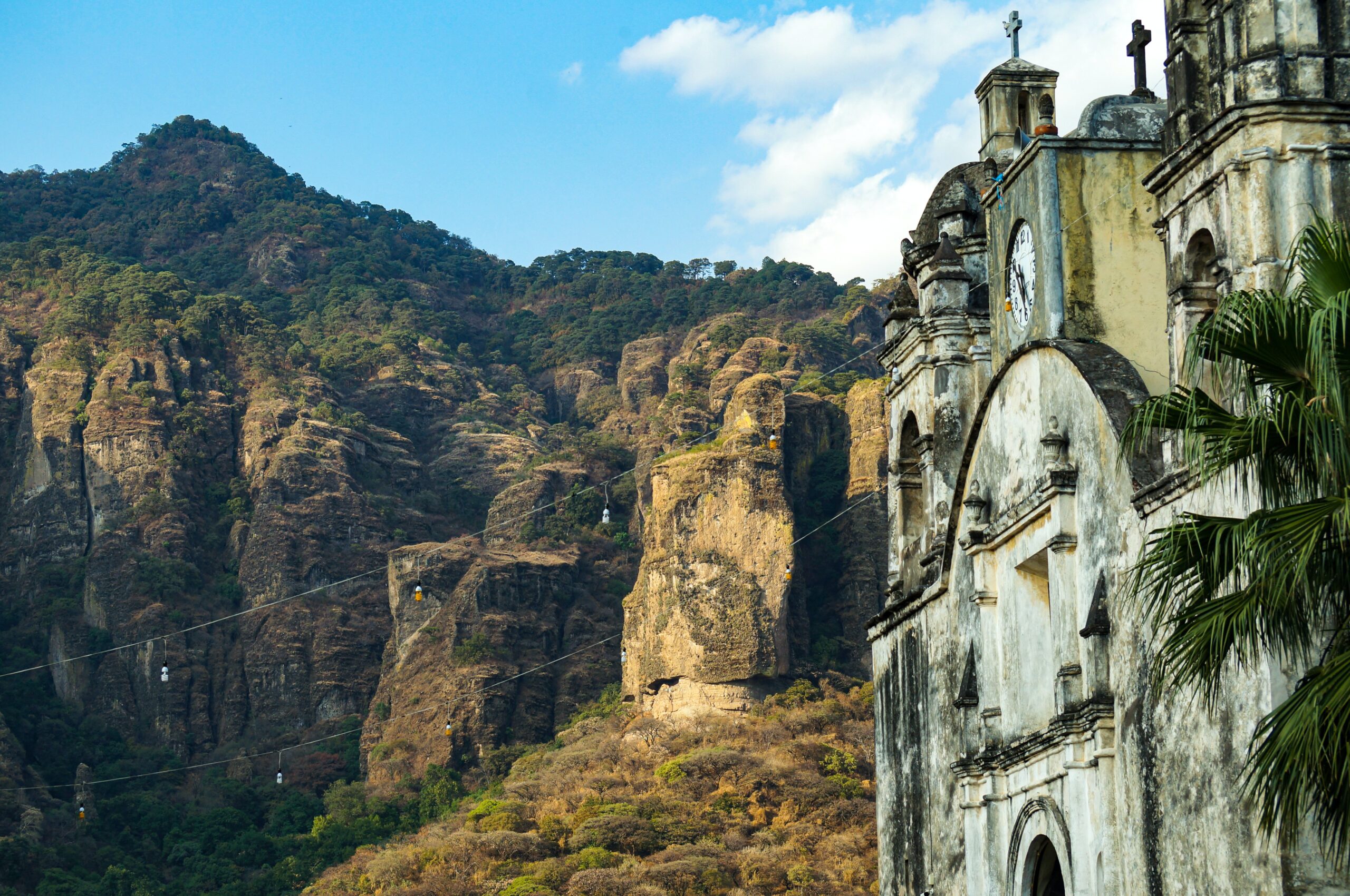 The Tepozteco Pyramid is located in the mountains of Mexico.
pictured: The Morelo Mountains and a aged church in front of the green forest