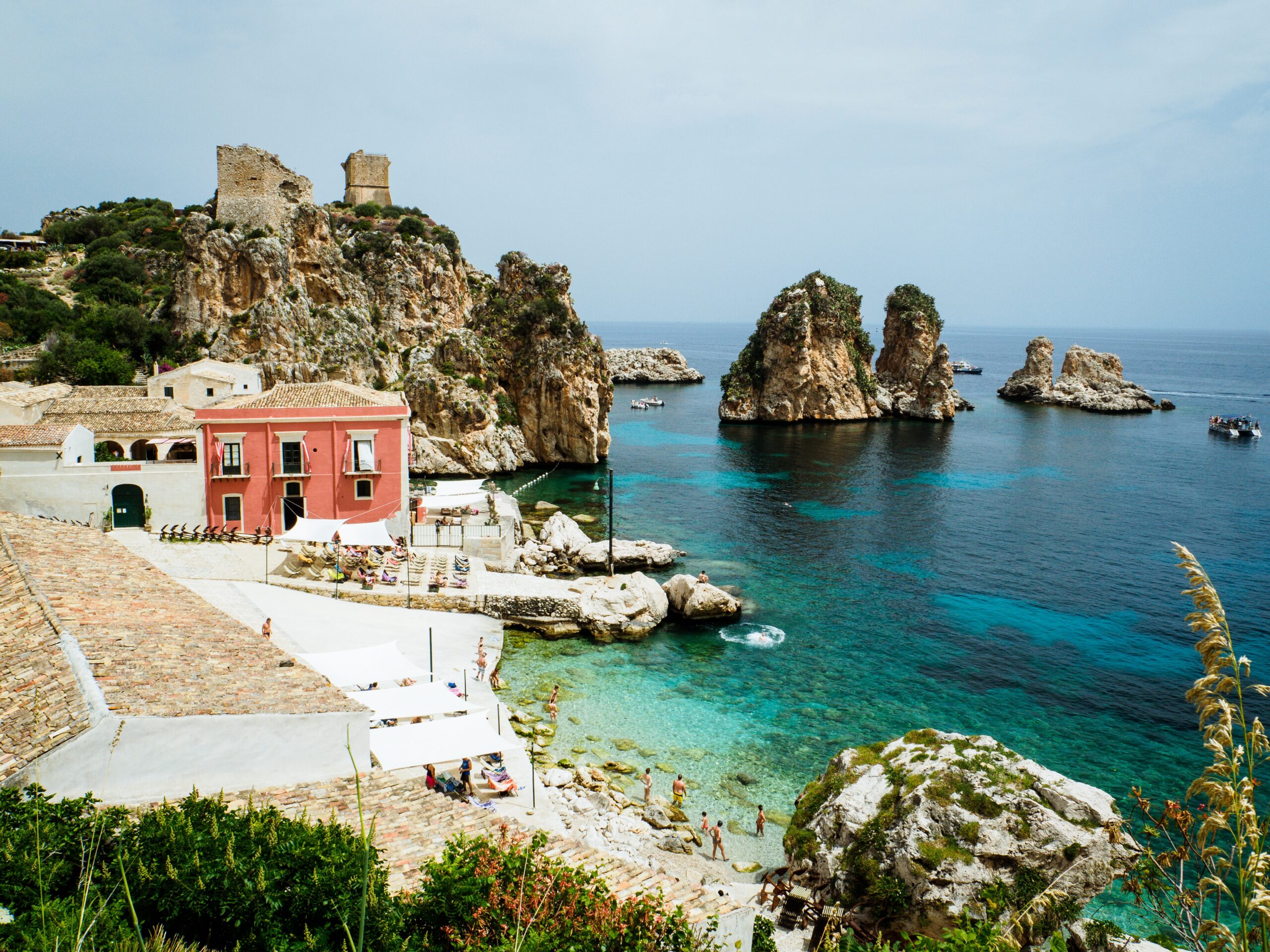 Sicily is one of the countryside regions of Italy that offers a unforgettable stay.
pictured: The Sicilian coast and a small village that borders the turquoise waters. 