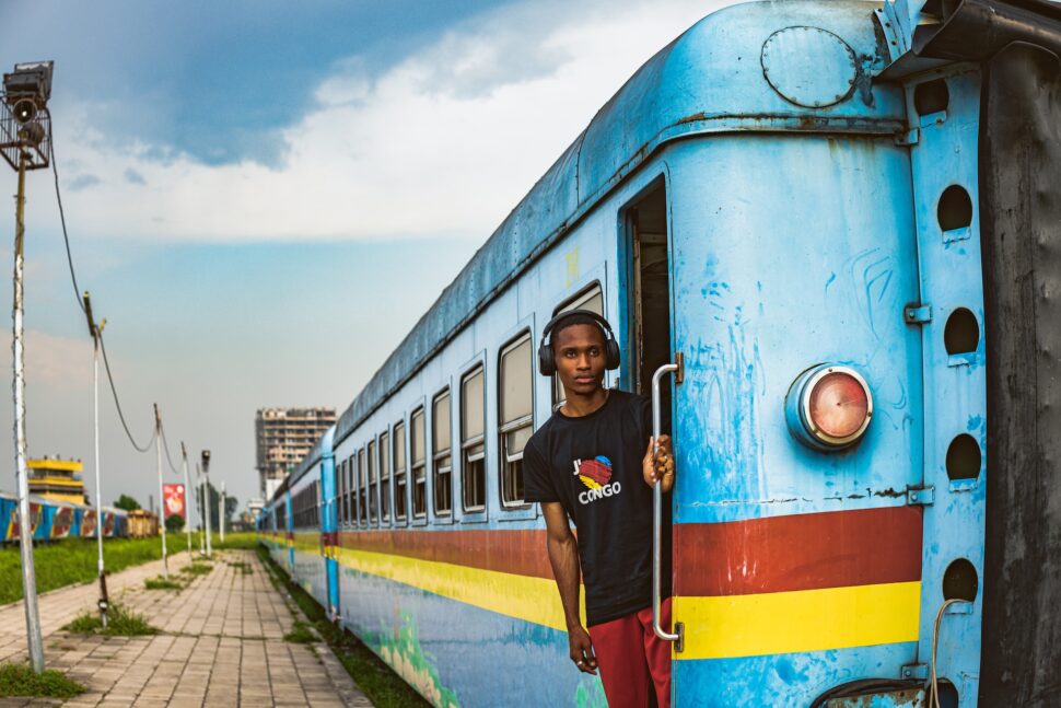 A boy leaning out of a train in Congo Kinshasa