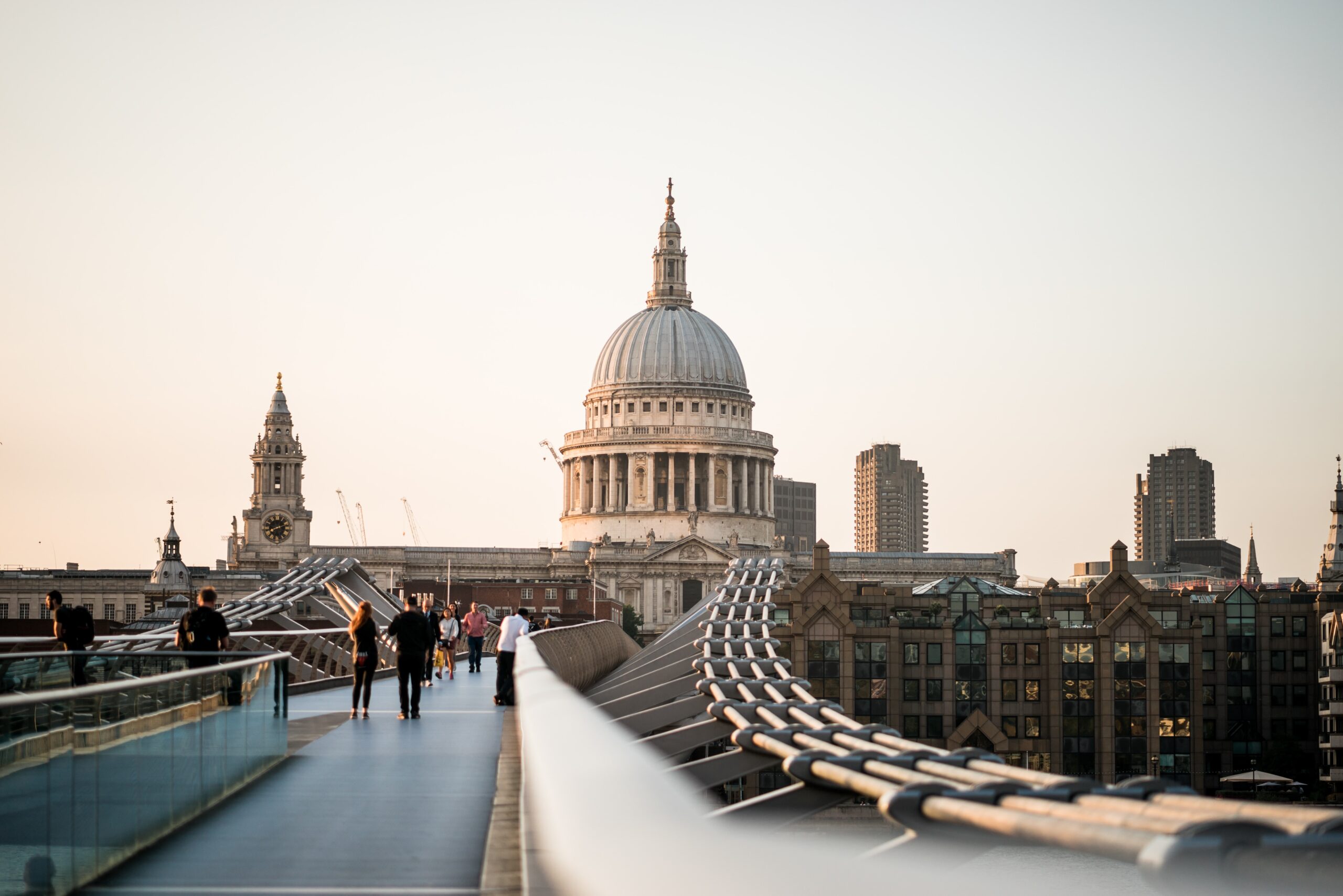 The inner city of London is home to the most popular attractions. Check out the attractions on the outskirts of the city that are just as important to see.
pictured: Millennium Bridge in London near sunset with locals leisurely walking around