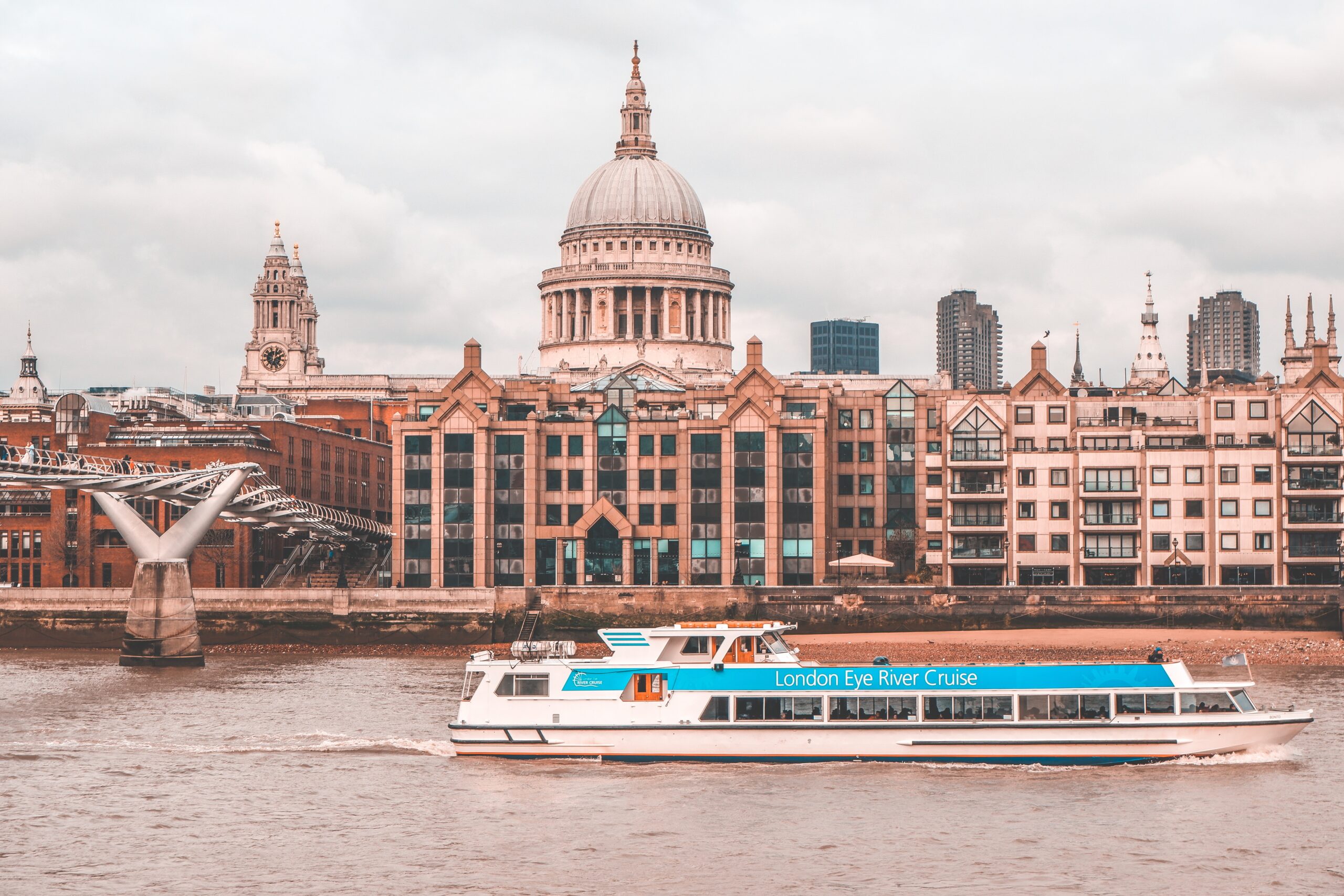 Thames River cruises provide the ultimate relaxation activity for visiting tourists that want to sit back and see all London has to offer. 
pictured: A river cruise boat riding along the Thames River in London