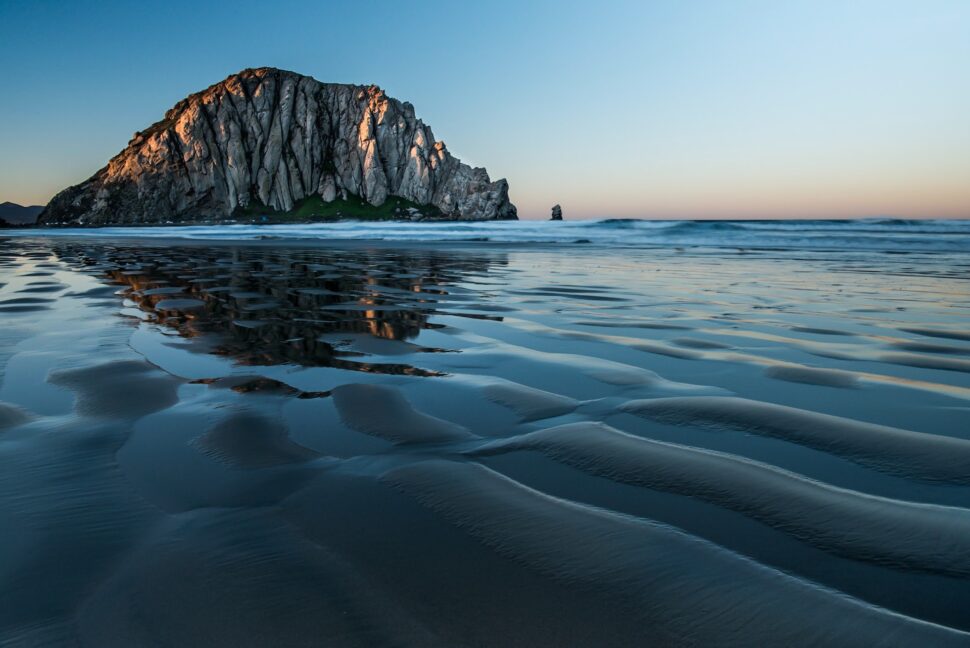The ocean and a large rock in Morro Bay. 