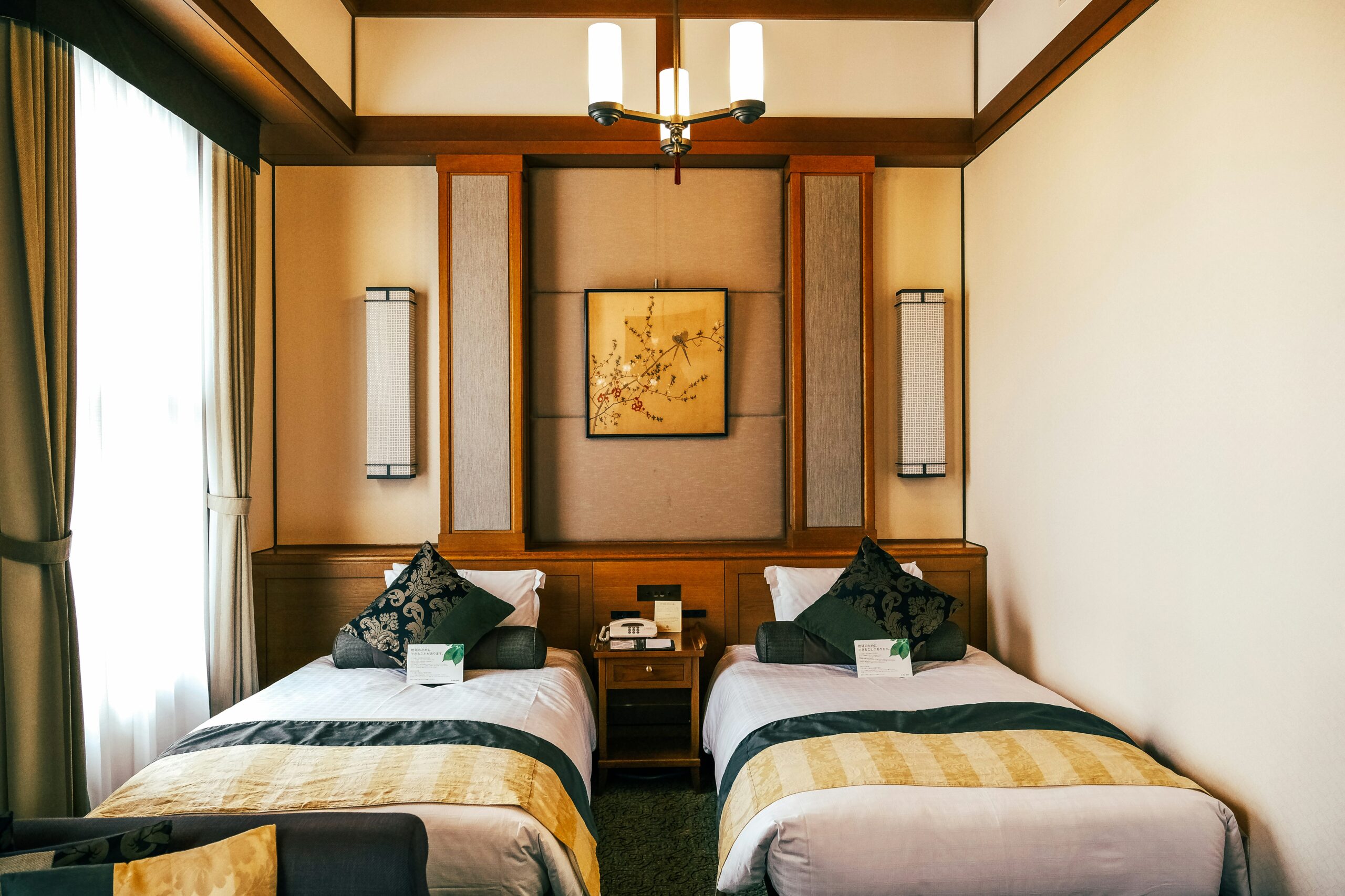 Akihabara is a anime cultural hub with many great accommodations to choose from. 
pictured: a modern Japanese hotel room with natural lighting and two twin sized beds