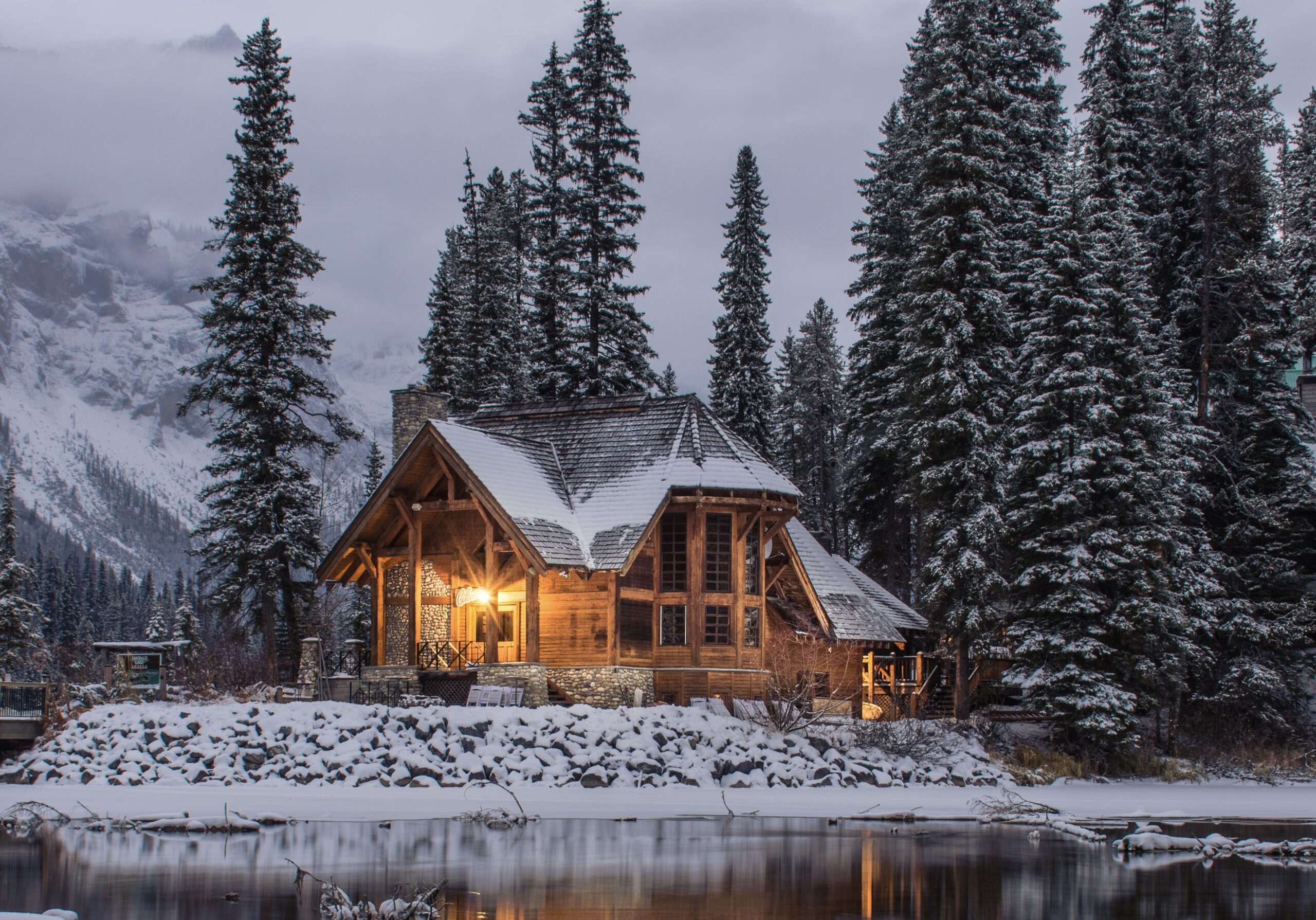Check out these winter destinations perfect for January travel. 
Pictured: a wooden cabin surrounded by pine trees and snow