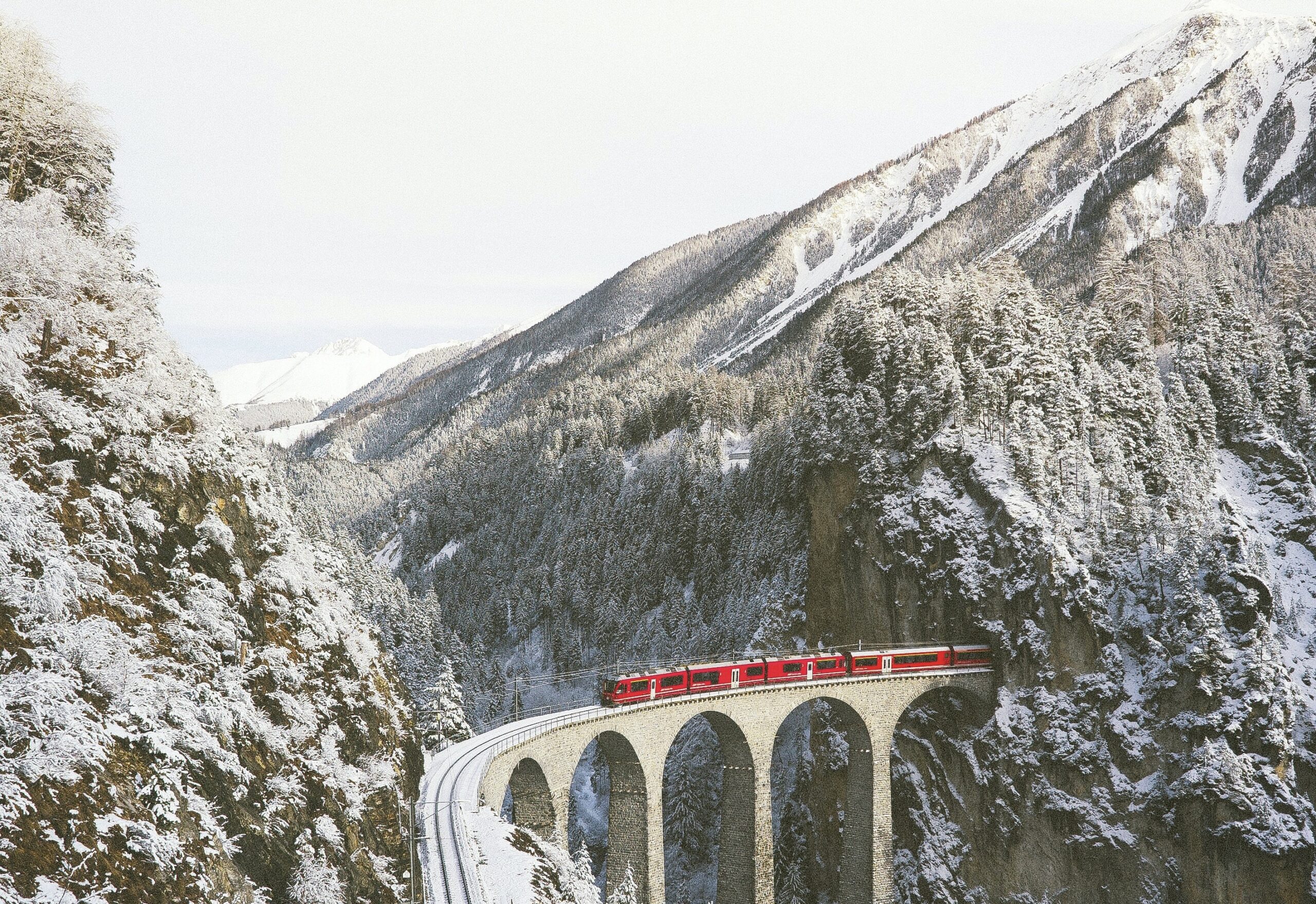 Switzerland is a dreamy winter vacation destination, especially in January. 
Pictured: the Switzerland train surrounded by snowy mountains 