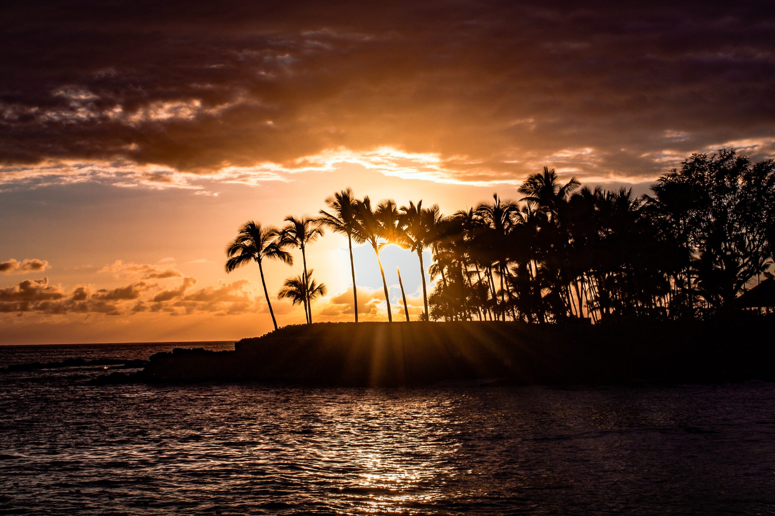Magic Sands Beach is a Hawaiian destination with interesting features. 
Pictured: the stunning Kona Beach during sunset 