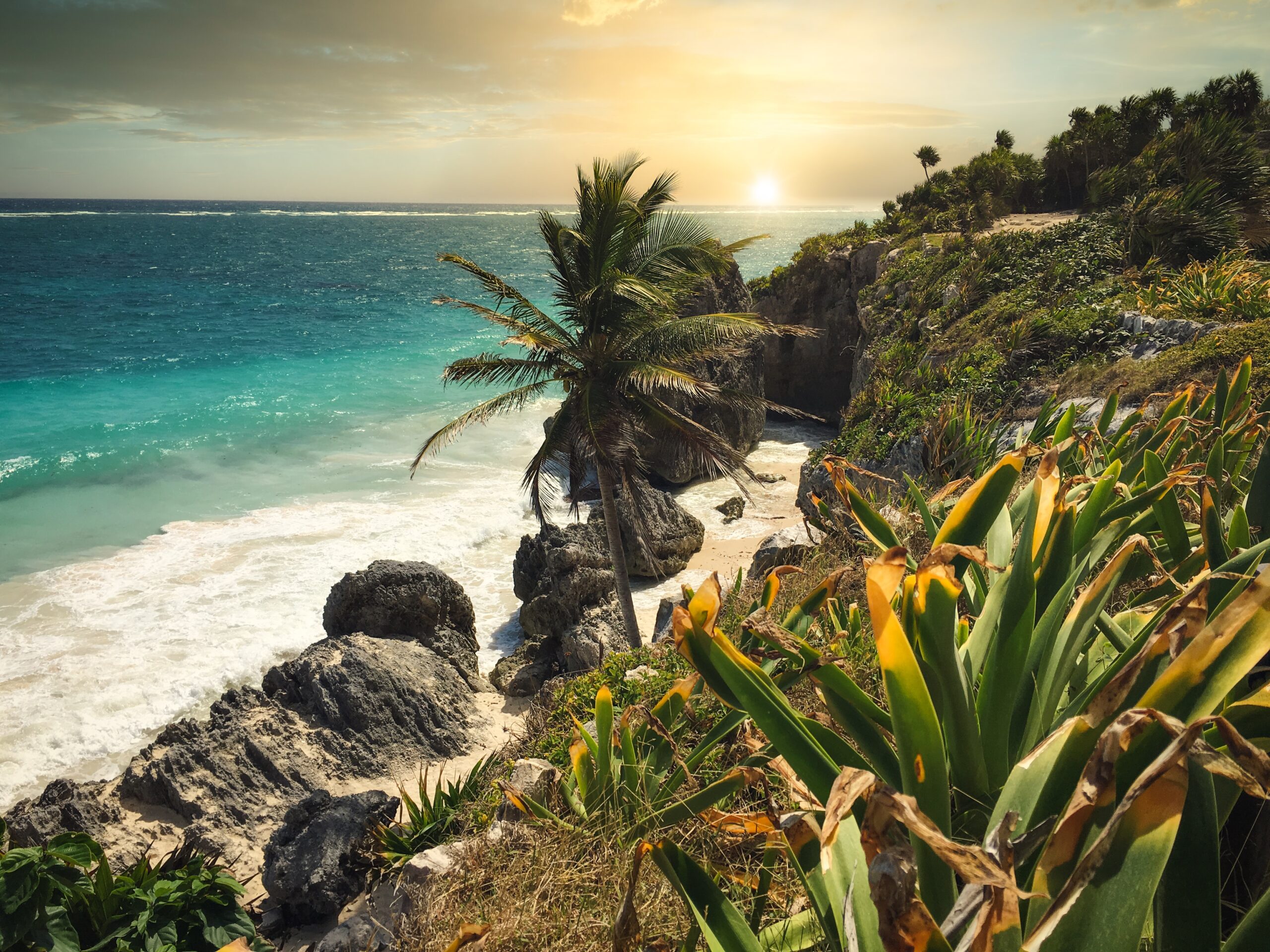 Tulum is  a safe Mexican destination that many travelers enjoy. 
Pictured: a lush beach in Tulum during sunset 