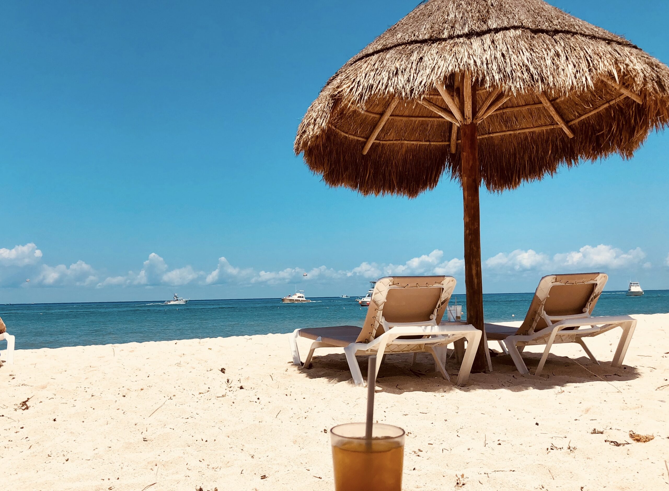 Cozumel, Mexico is one of the most popular vacation spots in Mexico. Learn more about the safe city.
Pictured: a Cancun beach with umbrellas and beach chairs on a sunny day 