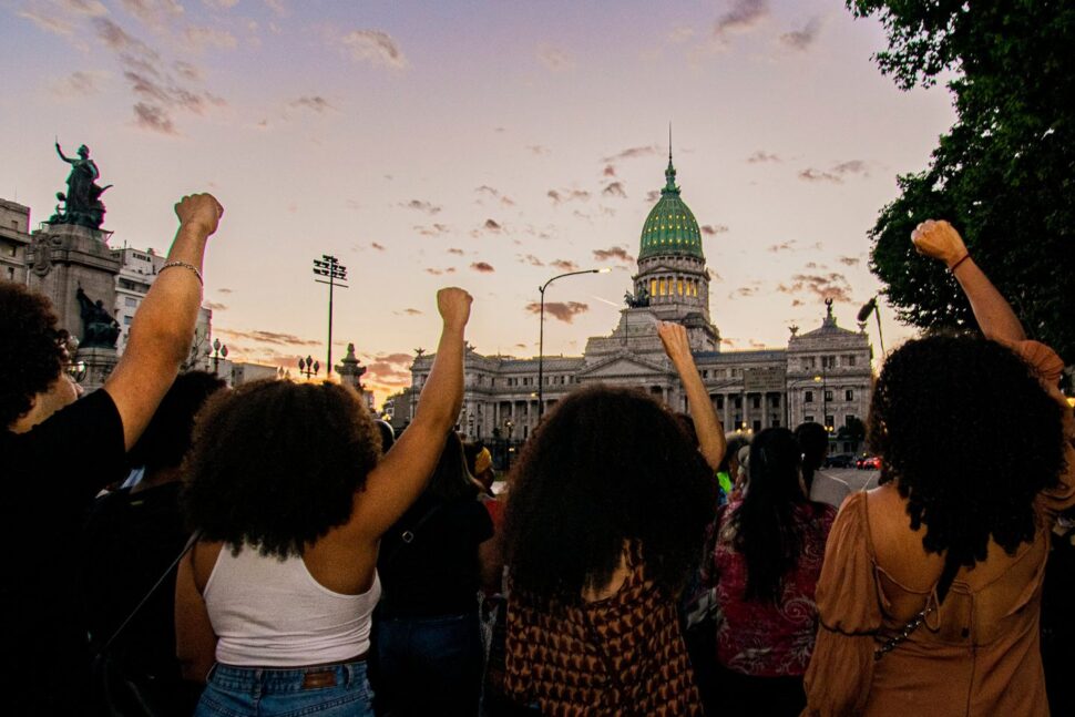 women raising fists at March in Argentina
