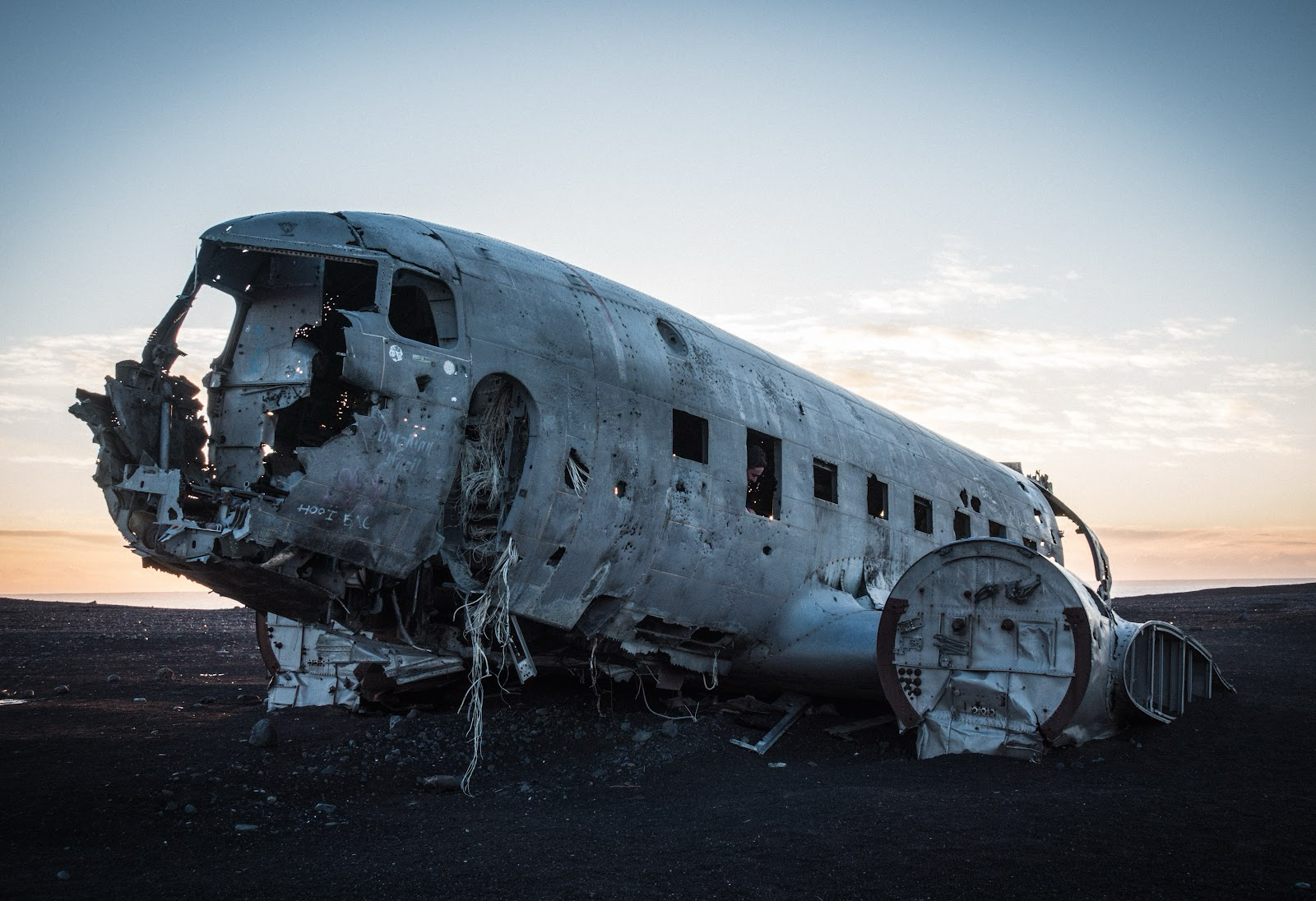 There are many boneyards throughout the country, which have sparked curiosity.  
Pictured: a plane with missing parts n a seemingly barren land during sunset