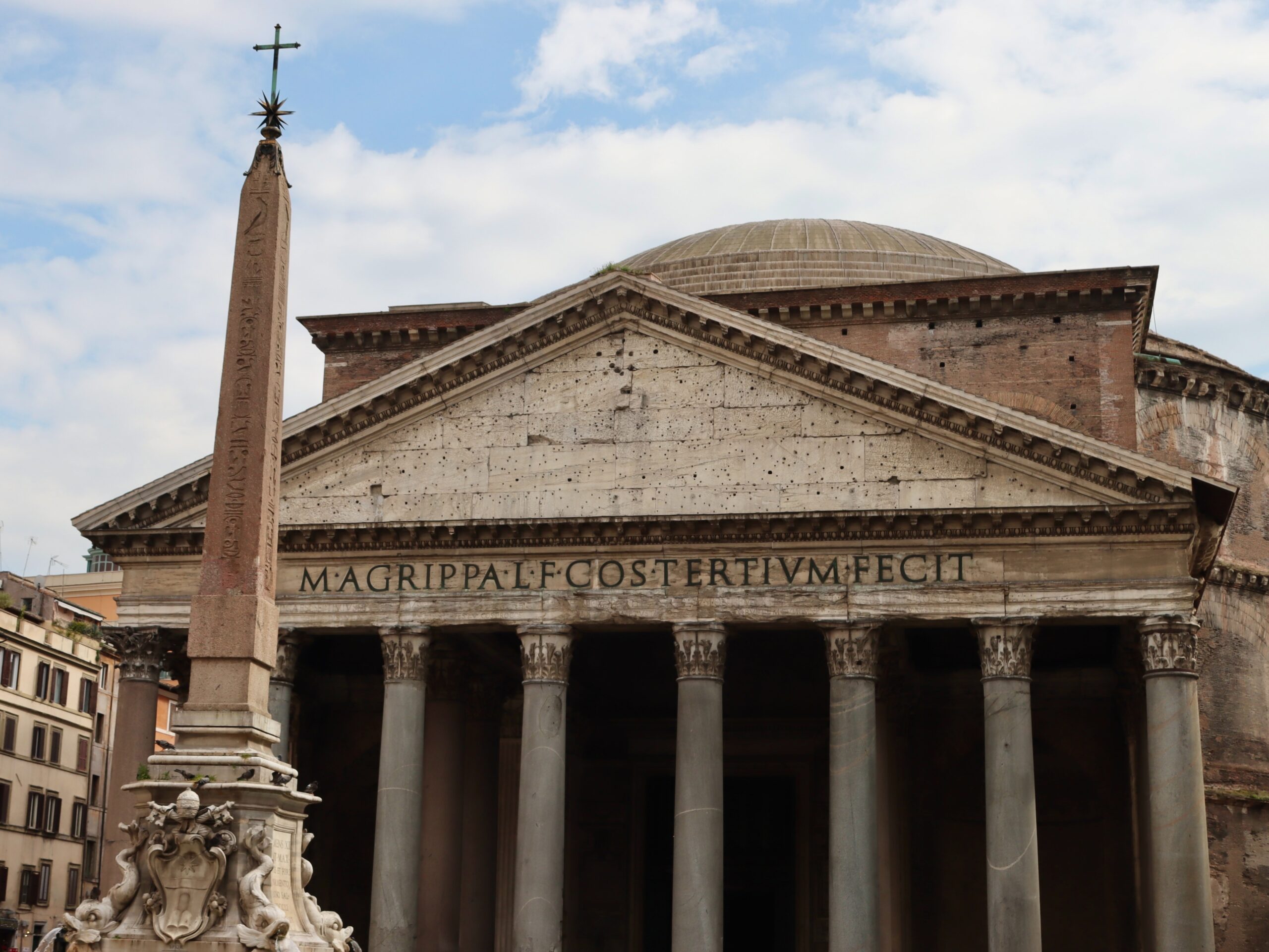 The Pantheon is a Roman ruin with a large dome, which still operates as a church. 
pictured: the exterior of the Pantheon in daylight 