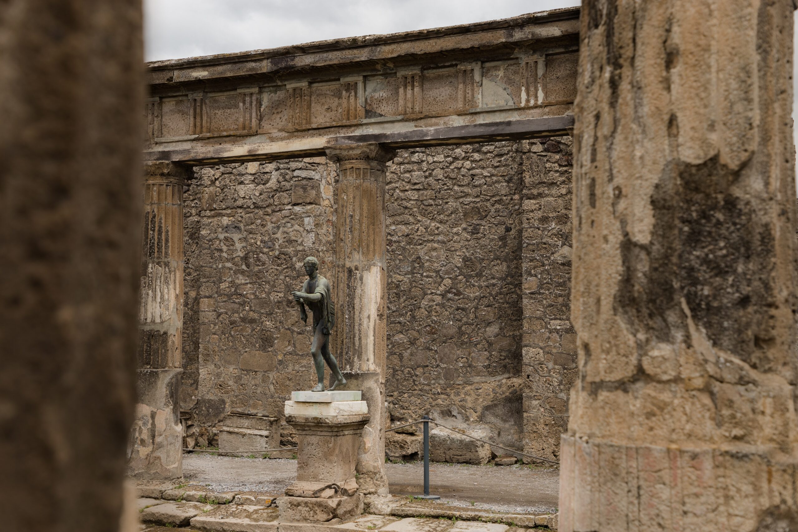 Pompeii is a significant site of Roman history.
pictured: A building and stature in Pompeii