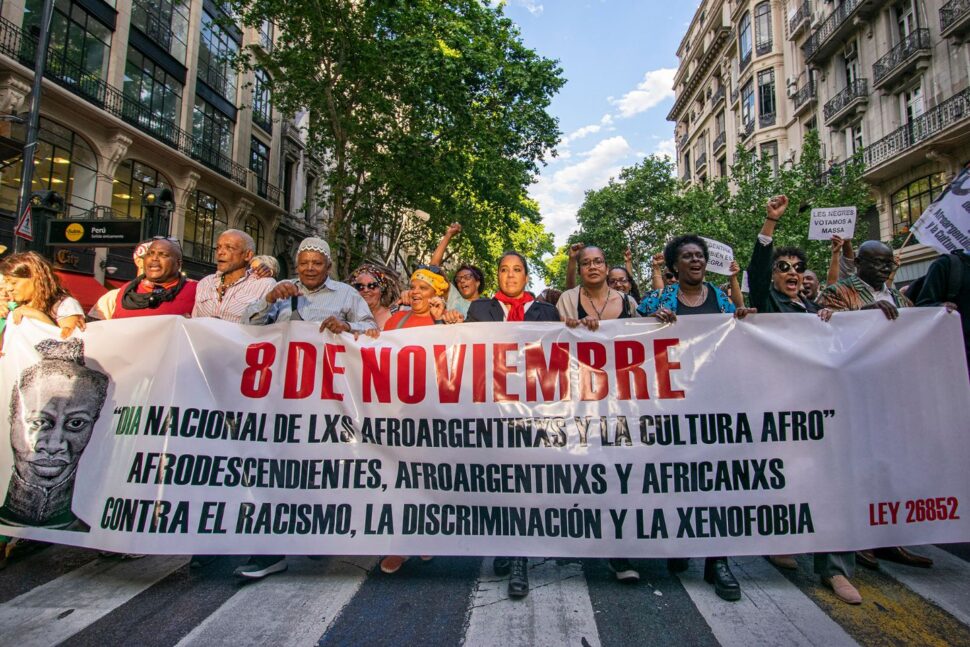 people walking with sign for Afro-Argentine