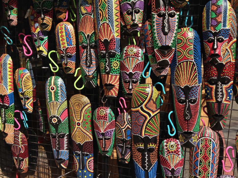 tribal masks hanging on a wall